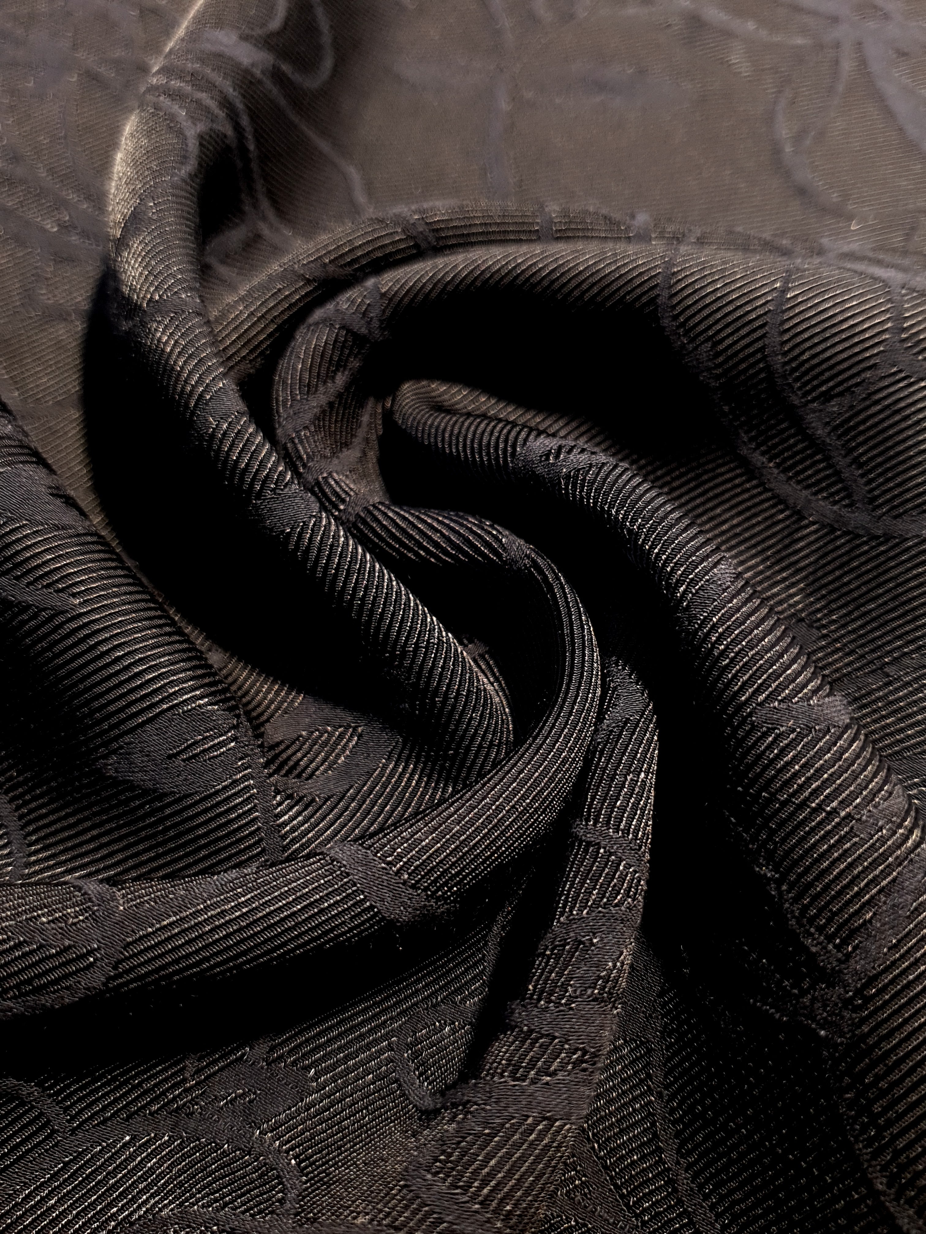 Drape detail of structured floral rayon jacquard for blouses.