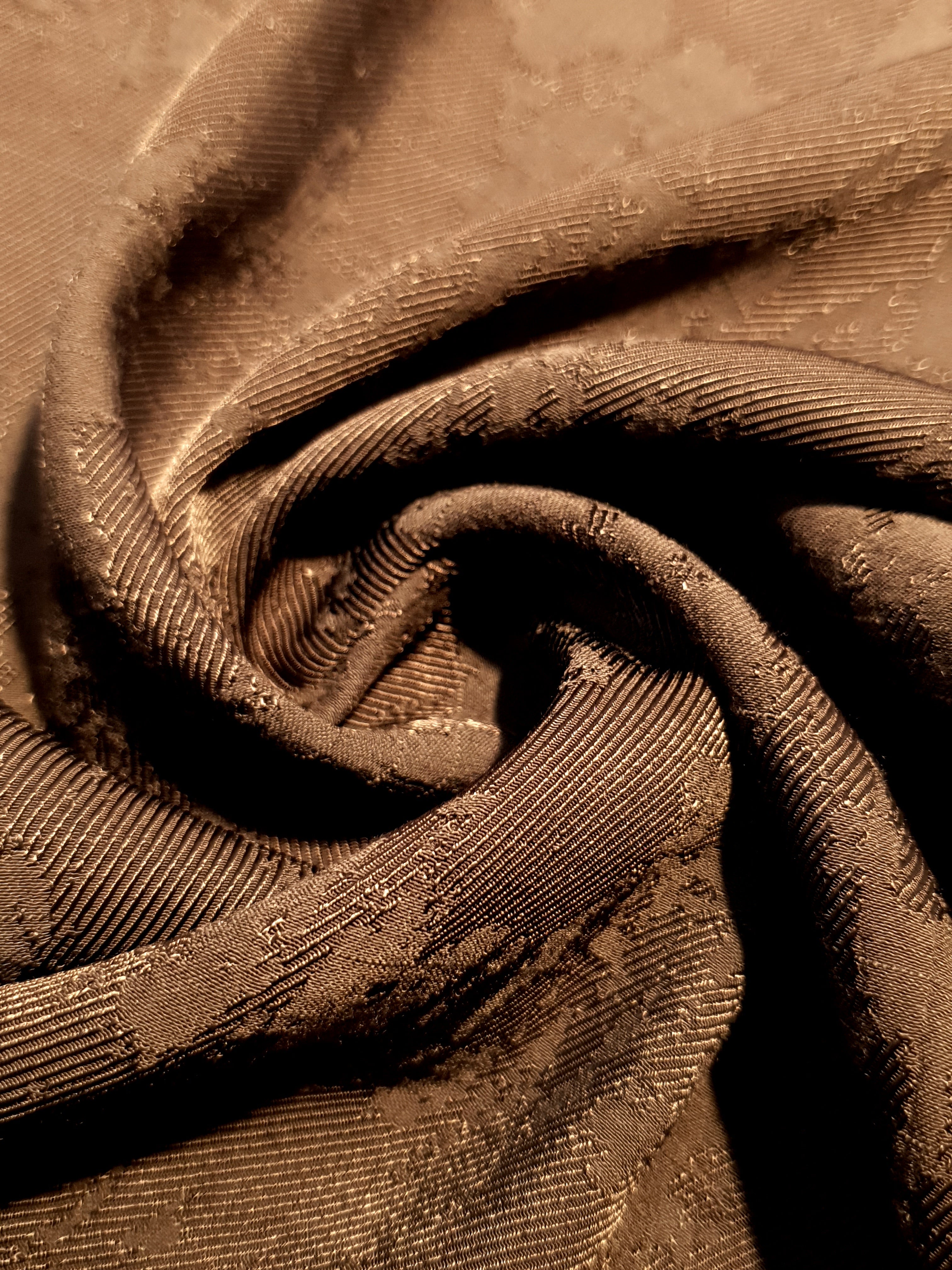 Drape detail of structured matrix motif jacquard for tailored layers.