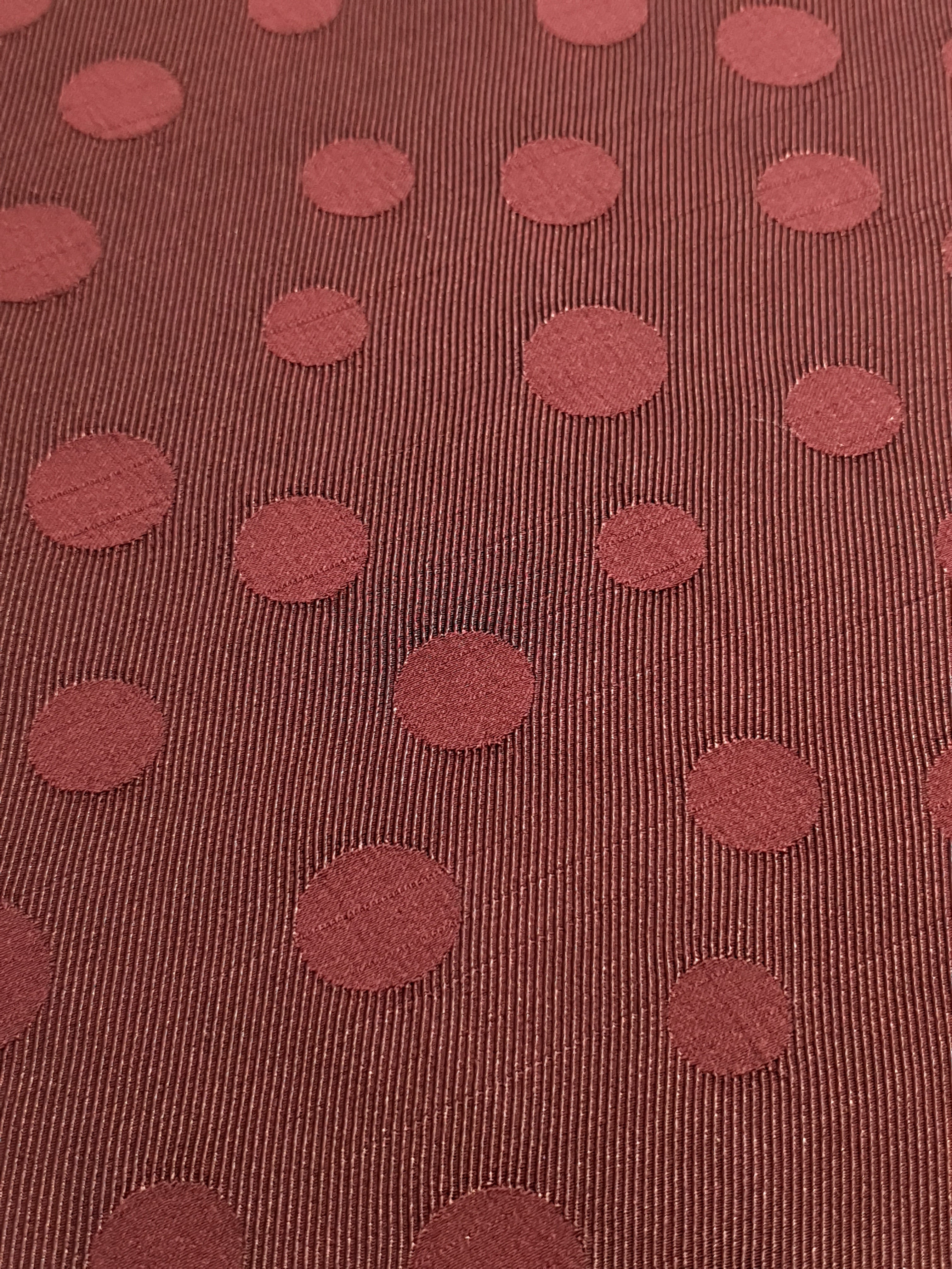 Close detail of polka dot rayon jacquard with woven surface.
