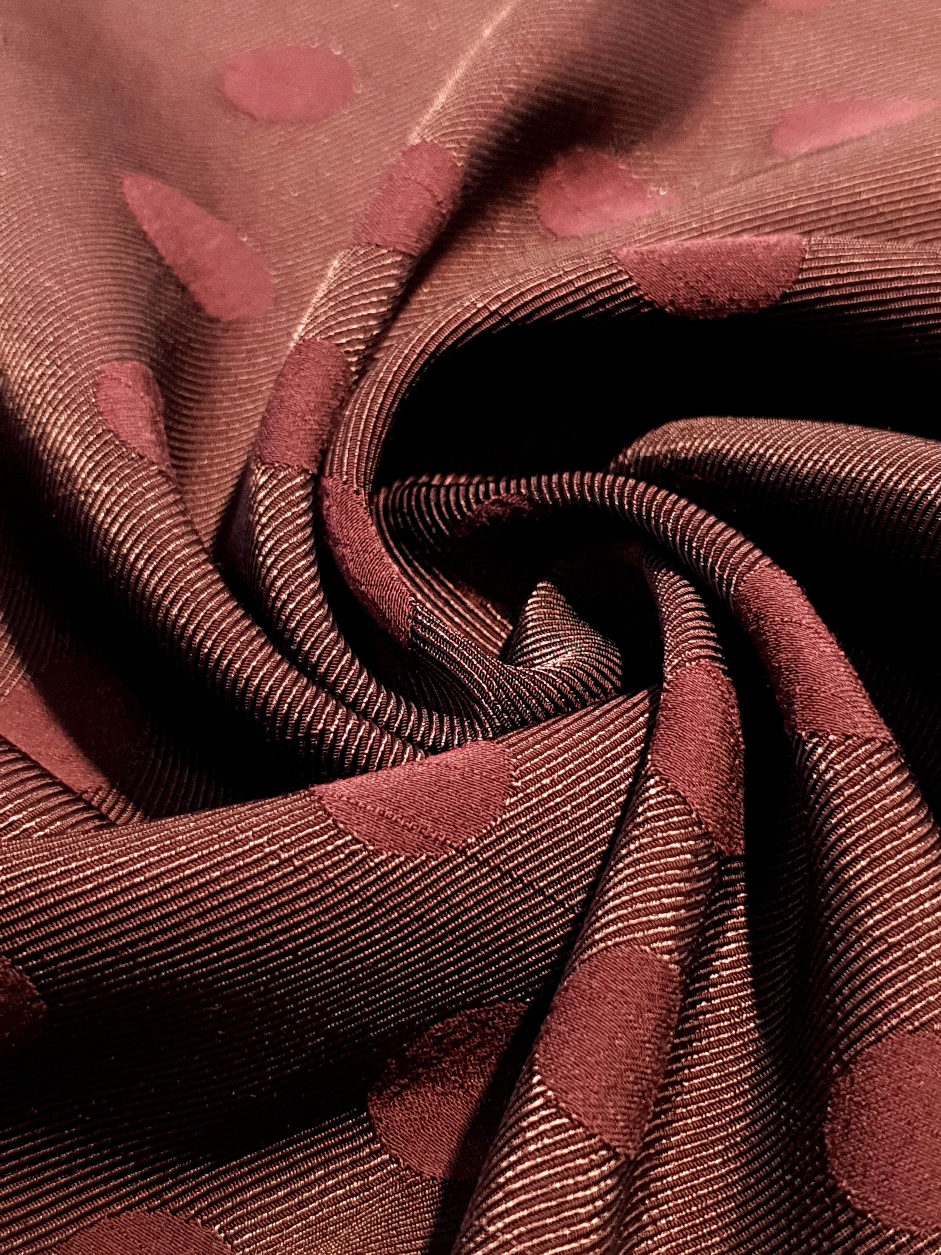 Drape detail of polka dot rayon jacquard for blouses and skirts.