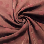 Polka dot rayon jacquard drape view with opaque woven body.