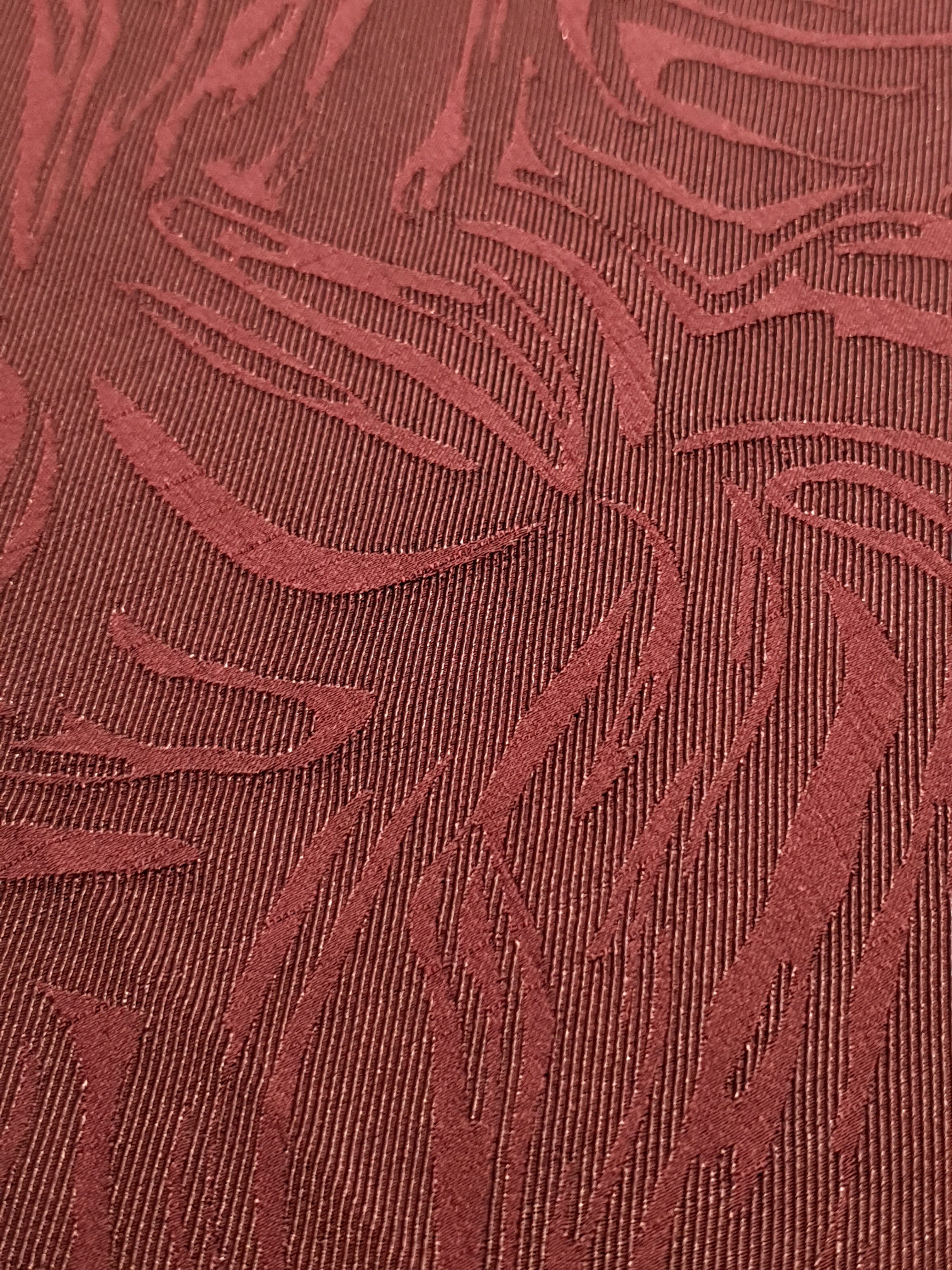 Close detail of seaweed motif rayon jacquard with raised woven pattern.