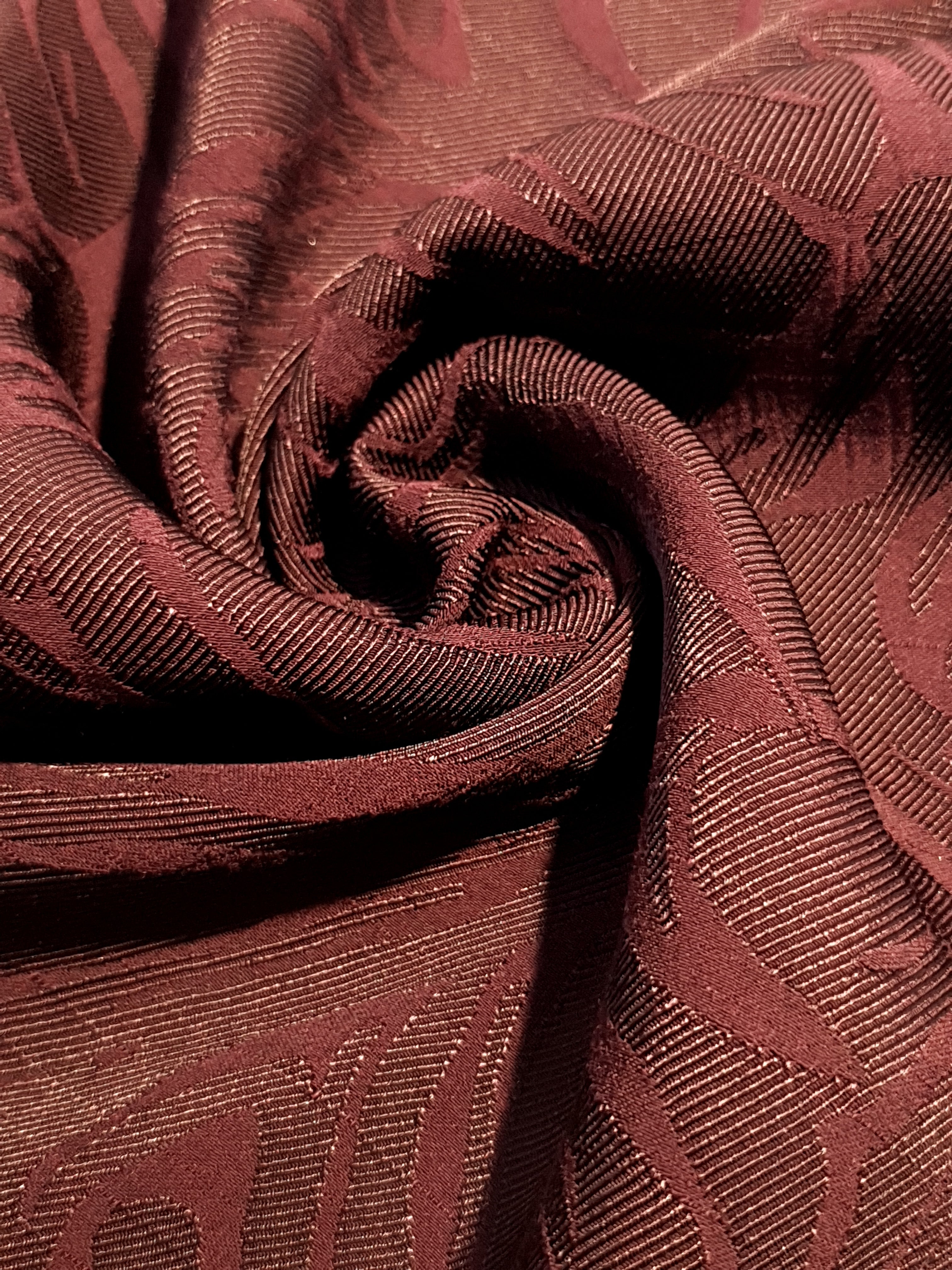 Drape detail of seaweed motif rayon jacquard for dresses and blouses.