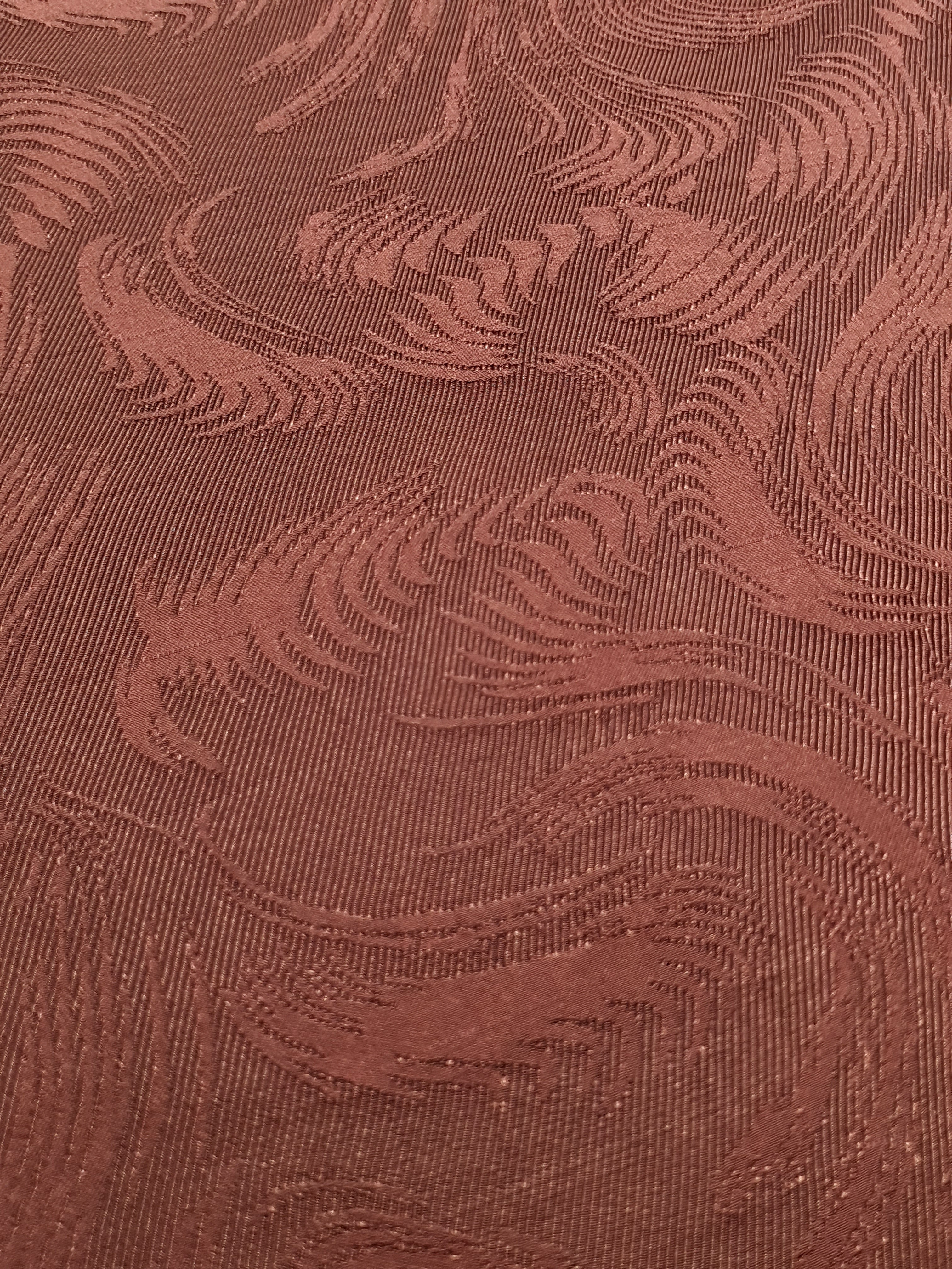 Close detail of swirl motif rayon jacquard with woven texture.