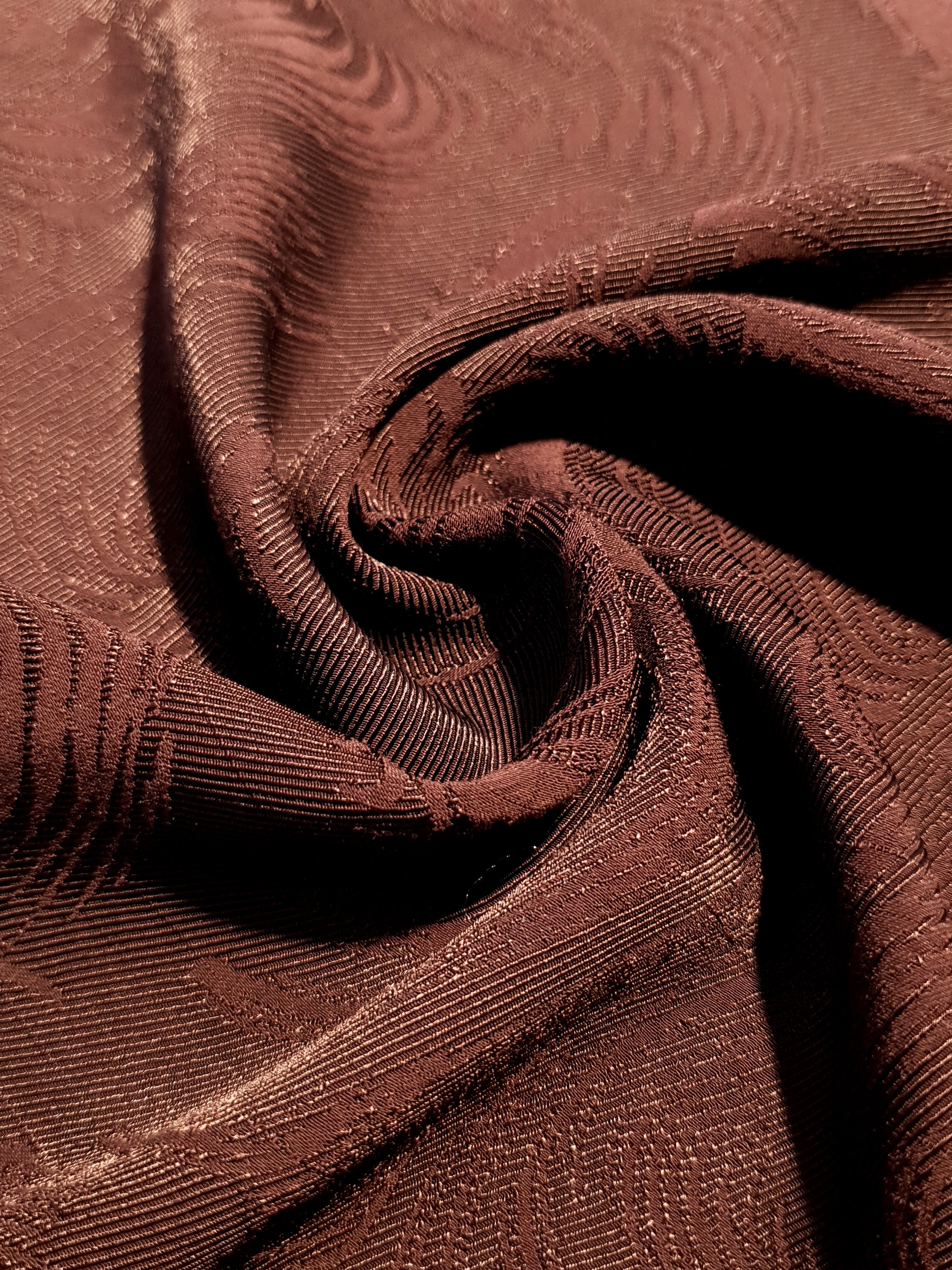 Drape detail of swirl motif rayon jacquard for dresses and skirts.