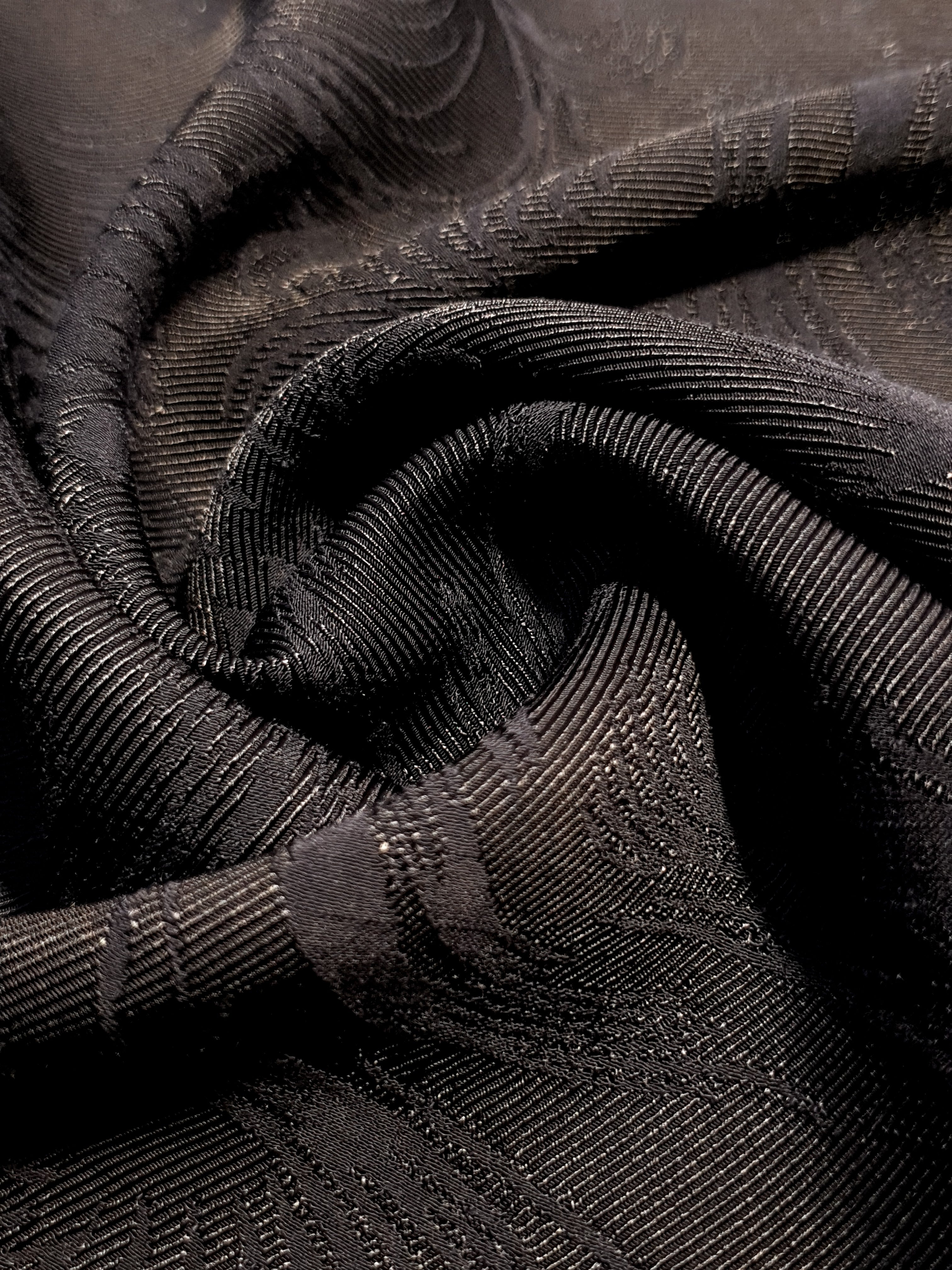Drape detail of structured swirl jacquard for tailored layers.