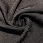 Structured swirl rayon jacquard drape view with soft crisp movement.