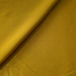 Close-up texture of Mustard Yellow sandwashed silky polyamide fabric