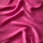 Close-up texture of Raspberry Pink sandwashed silky polyamide fabric