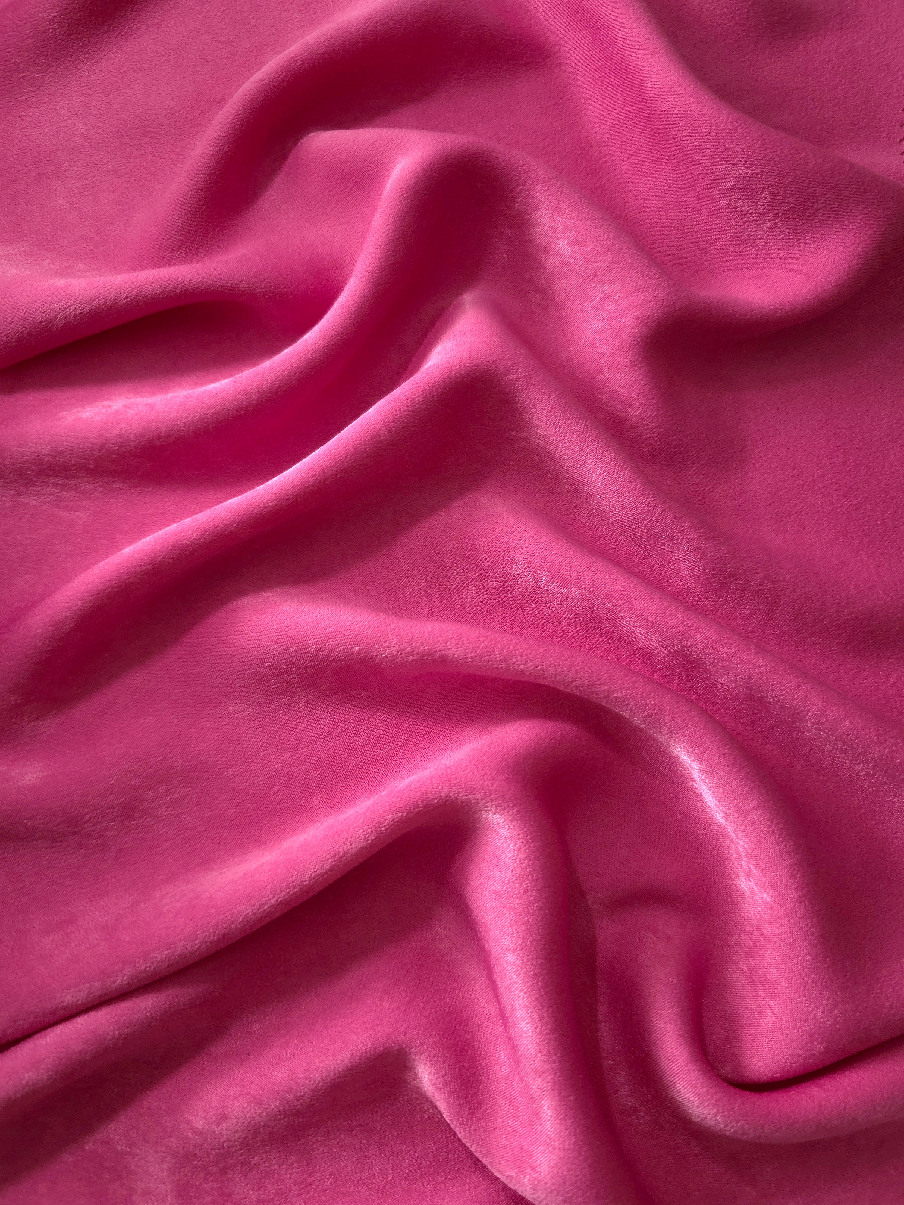 Close-up texture of Raspberry Pink sandwashed silky polyamide fabric