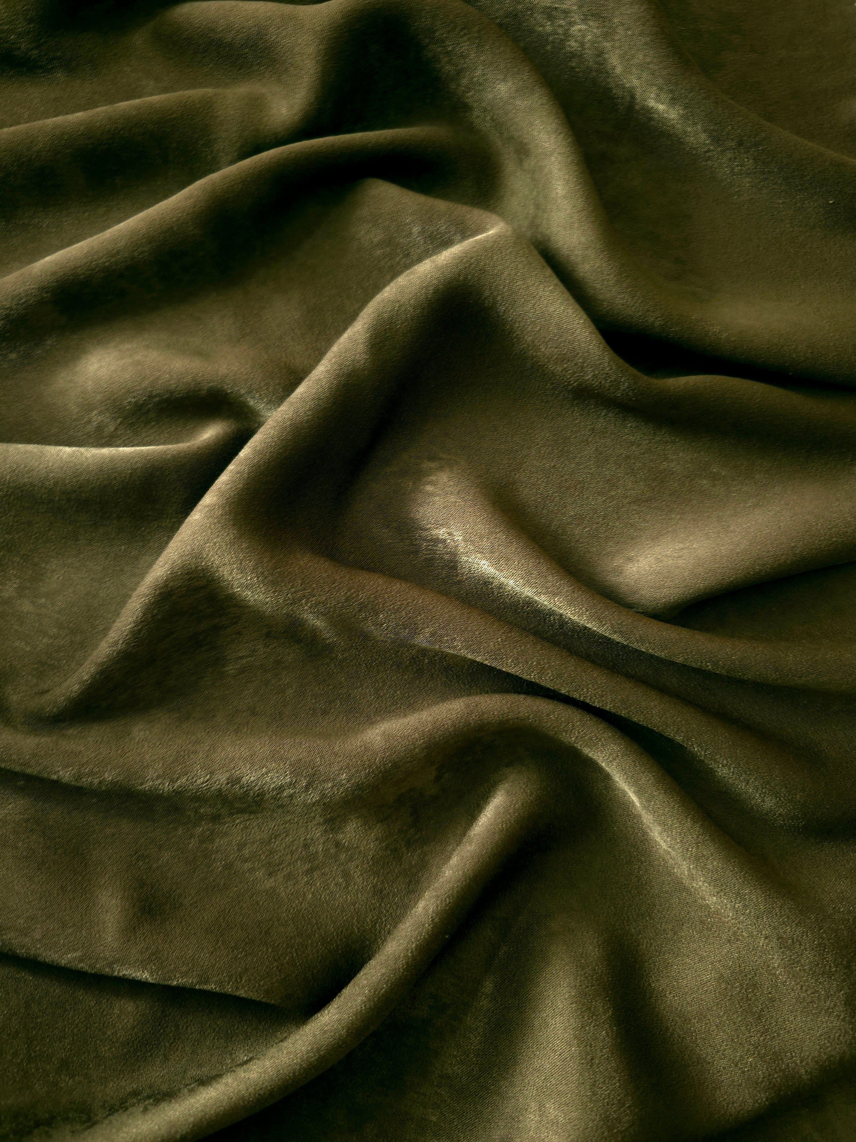 Close-up texture of Deep Olive sandwashed silky polyamide fabric