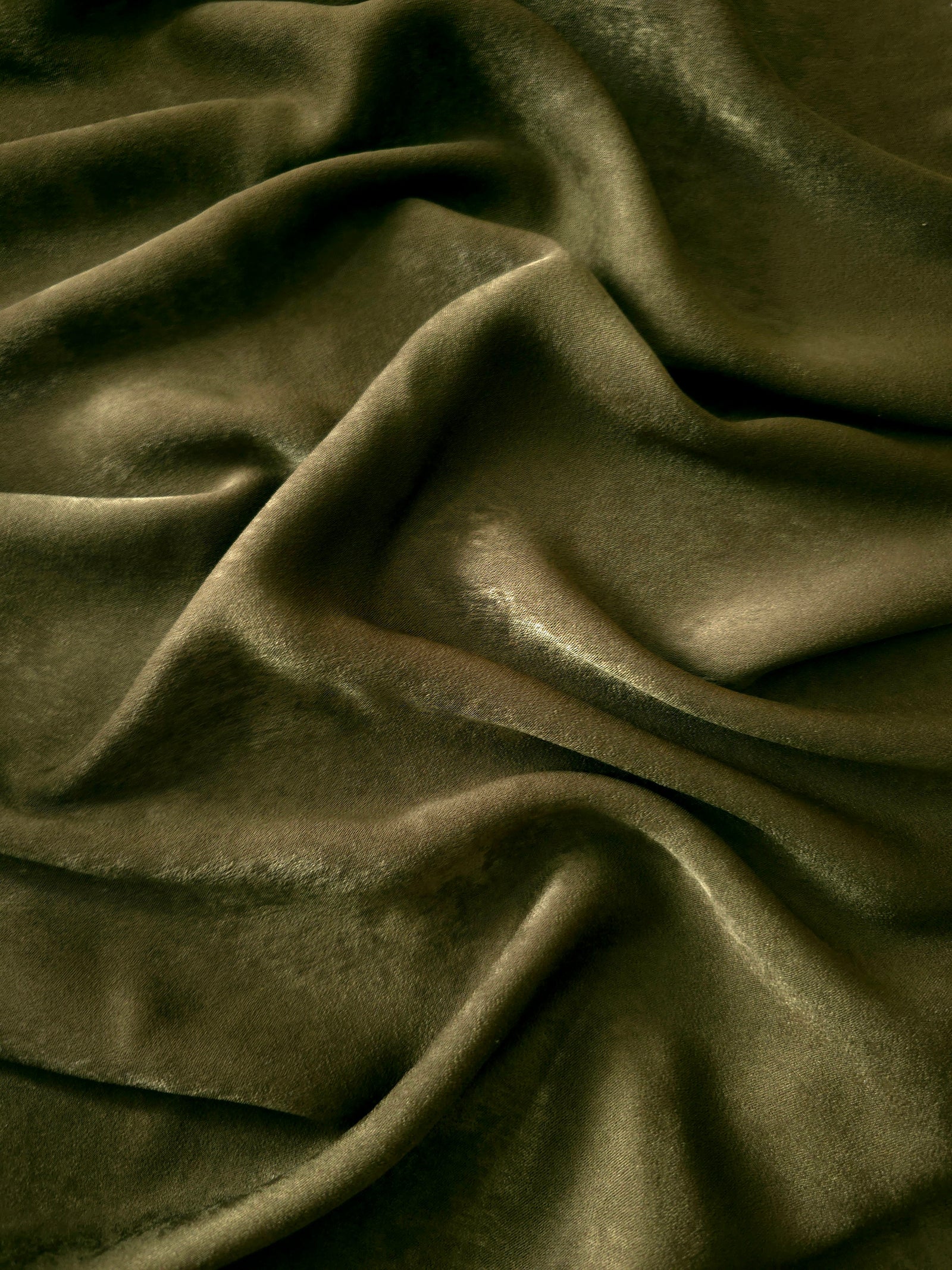 Close-up texture of Deep Olive sandwashed silky polyamide fabric