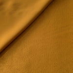 Close-up texture of Golden Brown sandwashed silky polyamide fabric