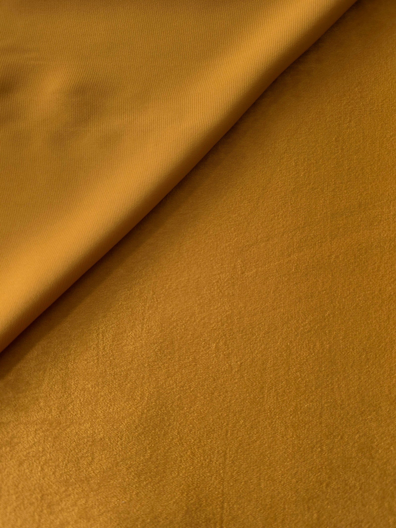 Close-up texture of Golden Brown sandwashed silky polyamide fabric