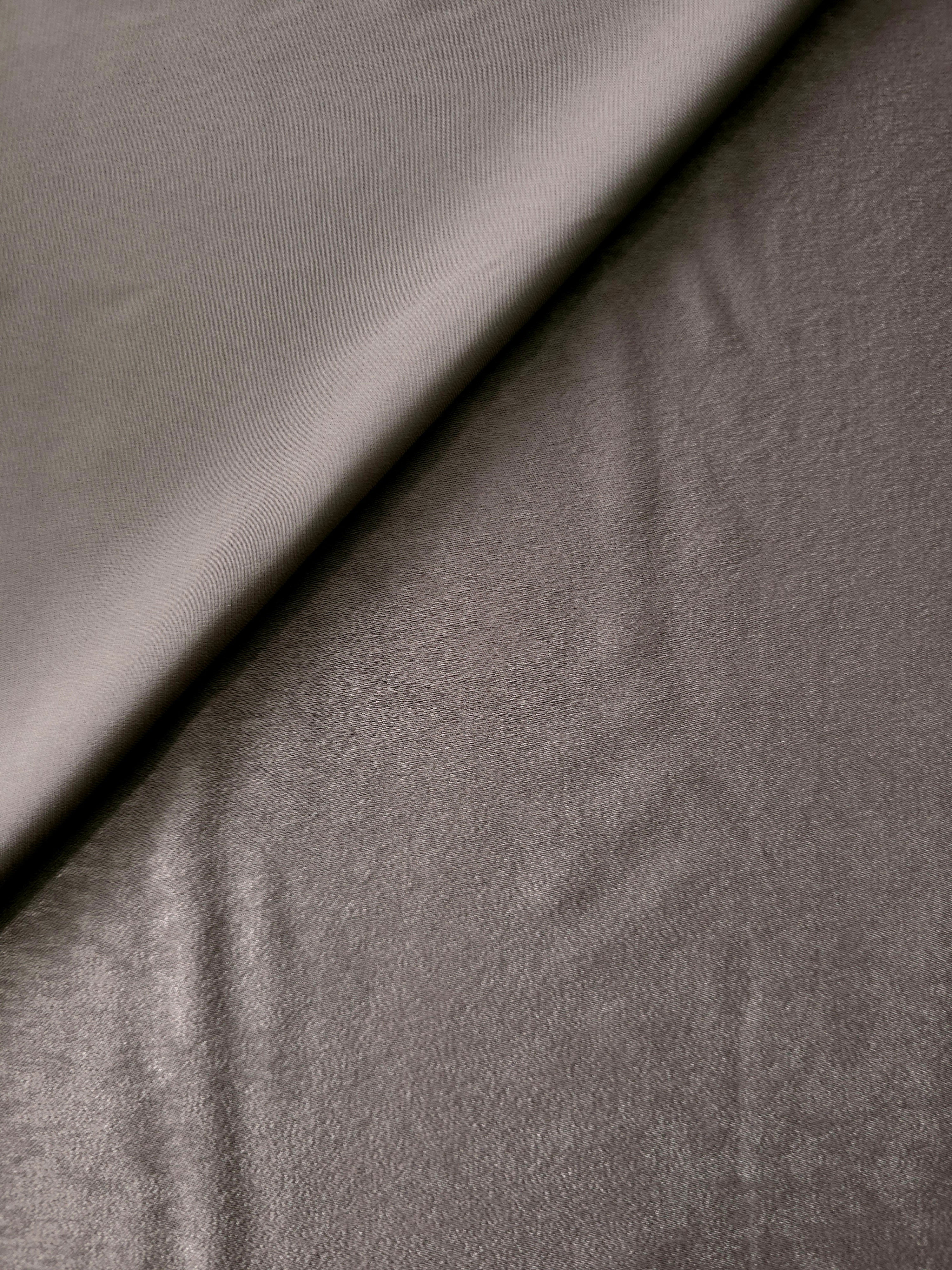 Close-up texture of Smoked Charcoal sandwashed silky polyamide fabric