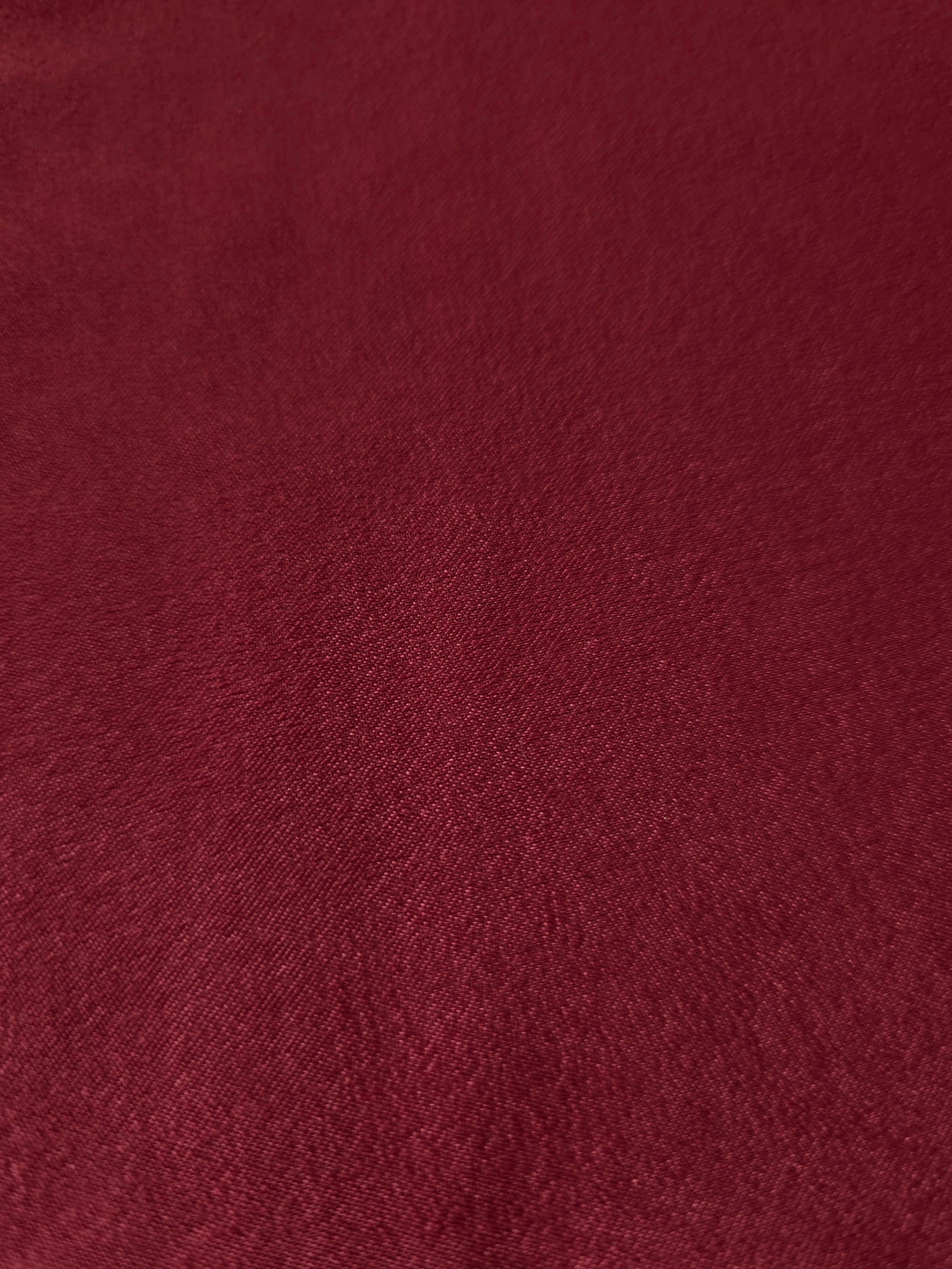 Close-up texture of Deep Burgundy sandwashed silky polyamide fabric