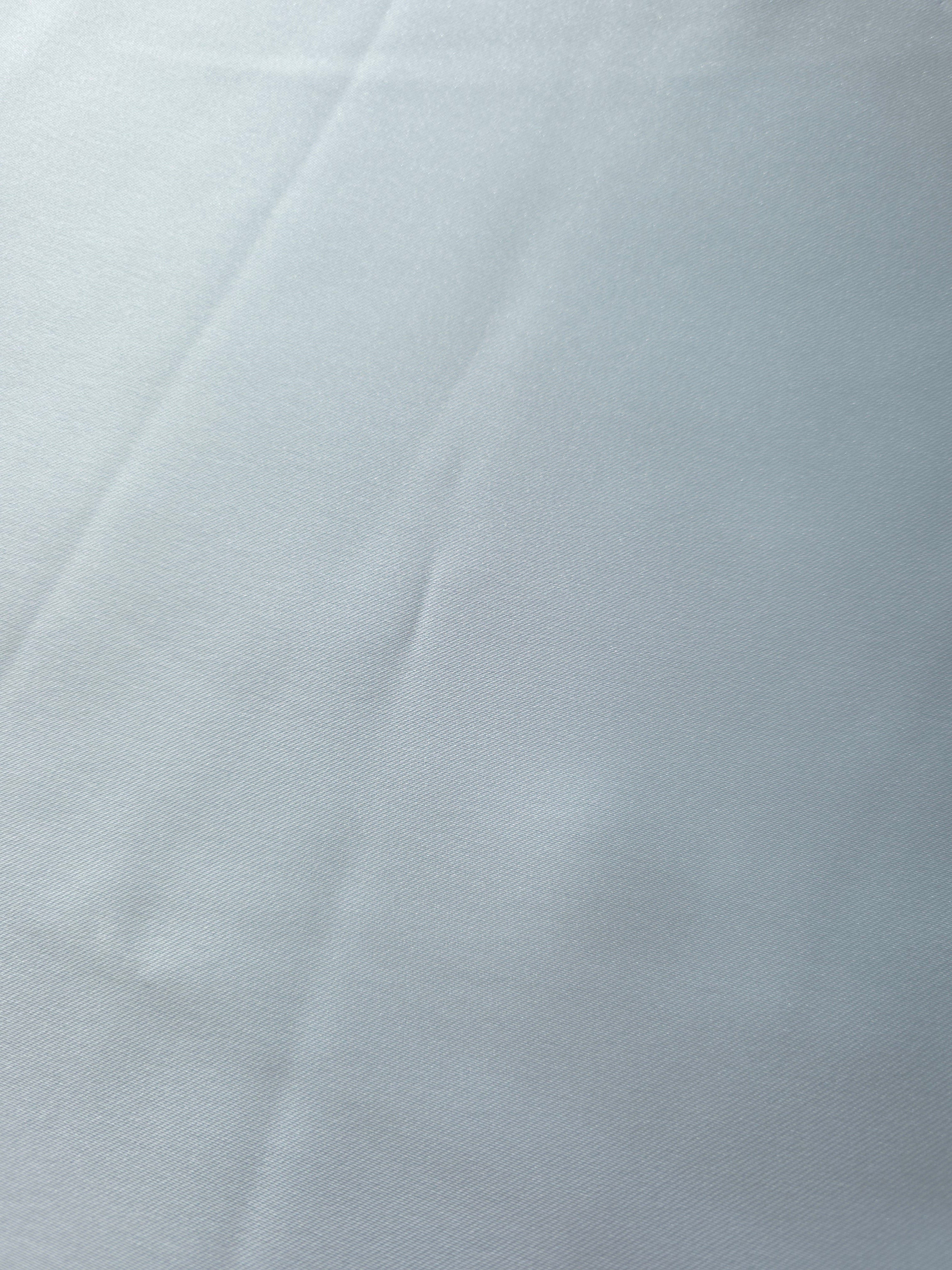 Surface detail of Baby Blue silky satin showing an even glossy face for scarves, sash details and refined fashion accessories.