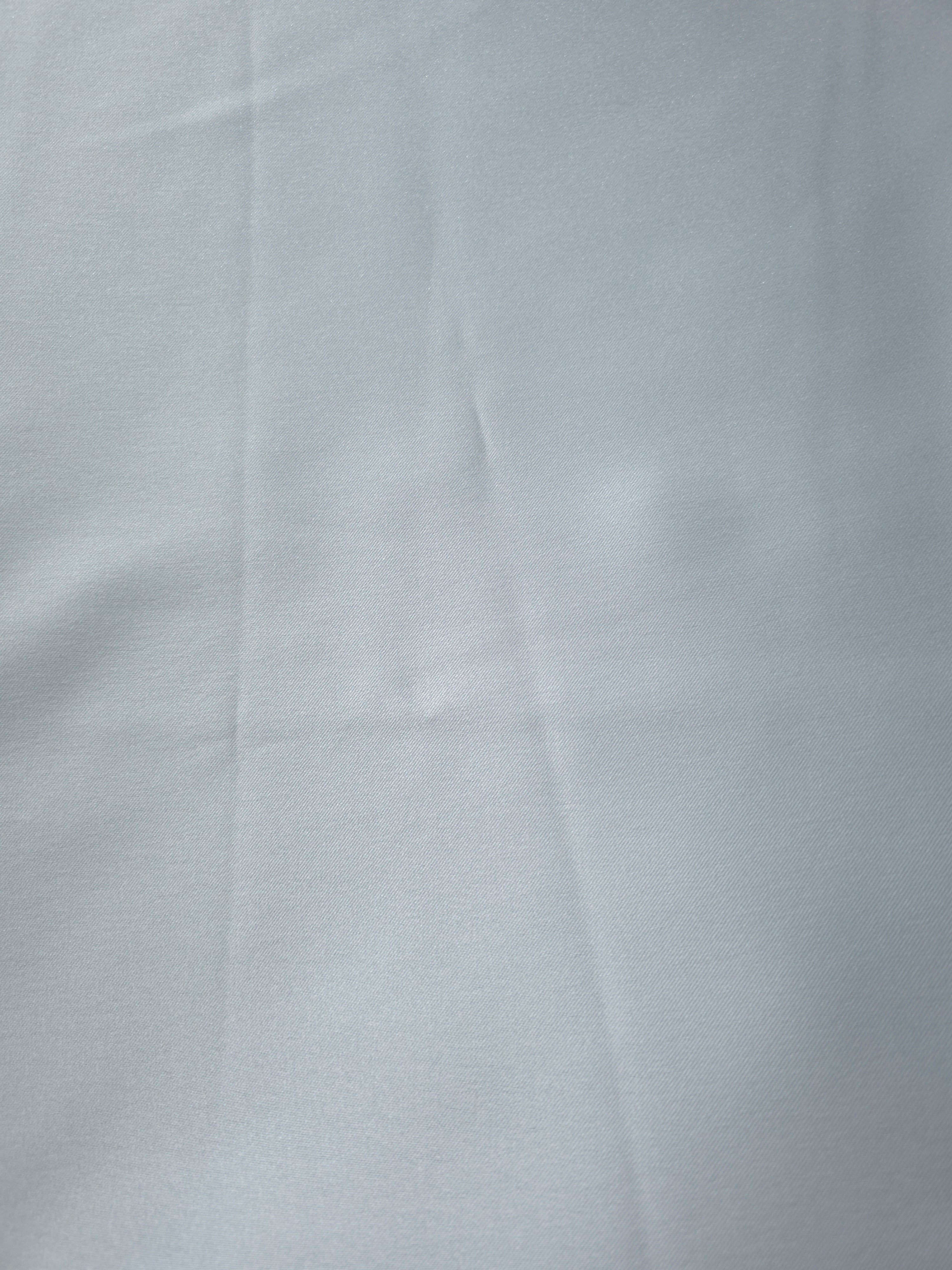 Close-up of Baby Blue satin fabric emphasizing its smooth lustrous texture for blouse fronts, delicate tops and elegant lining applications.