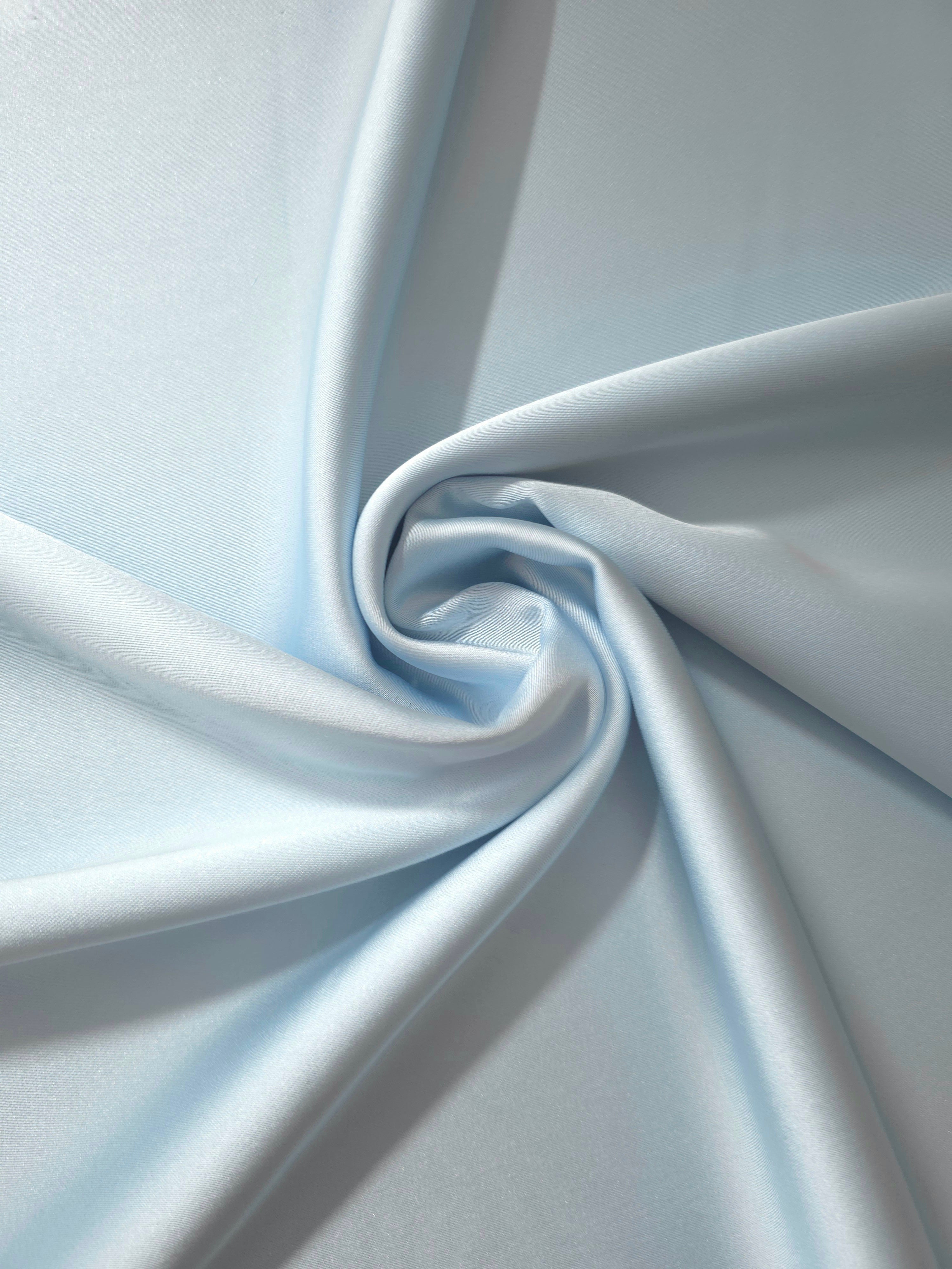 Twisted drape of Baby Blue silky satin demonstrates flowing movement and light reflection for prom dresses, bias-cut skirts and draped necklines.
