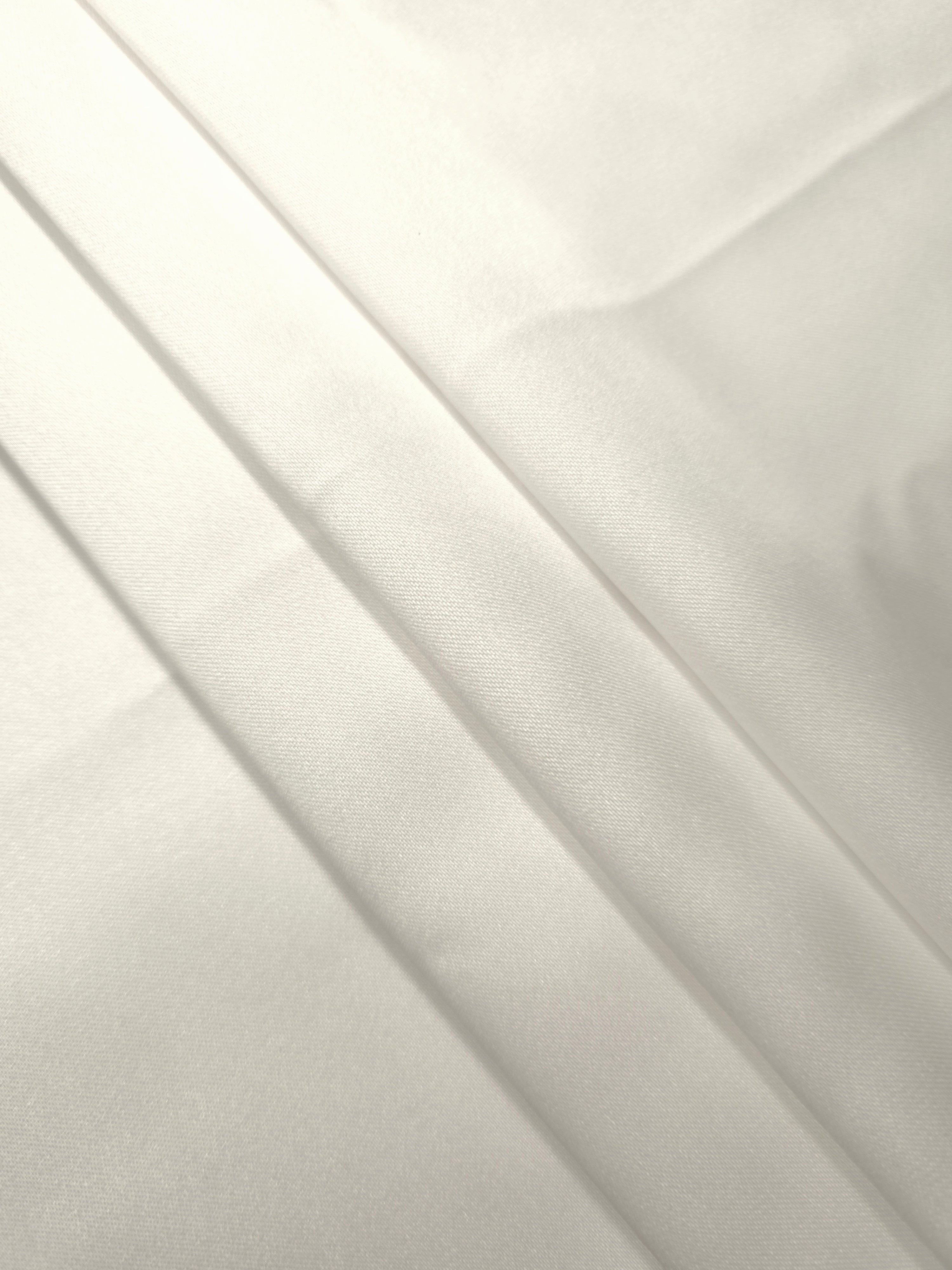 Cloud White satin arranged in soft folds, emphasizing airy elegance for bridal robes, slip dresses and layered wedding ensembles.
