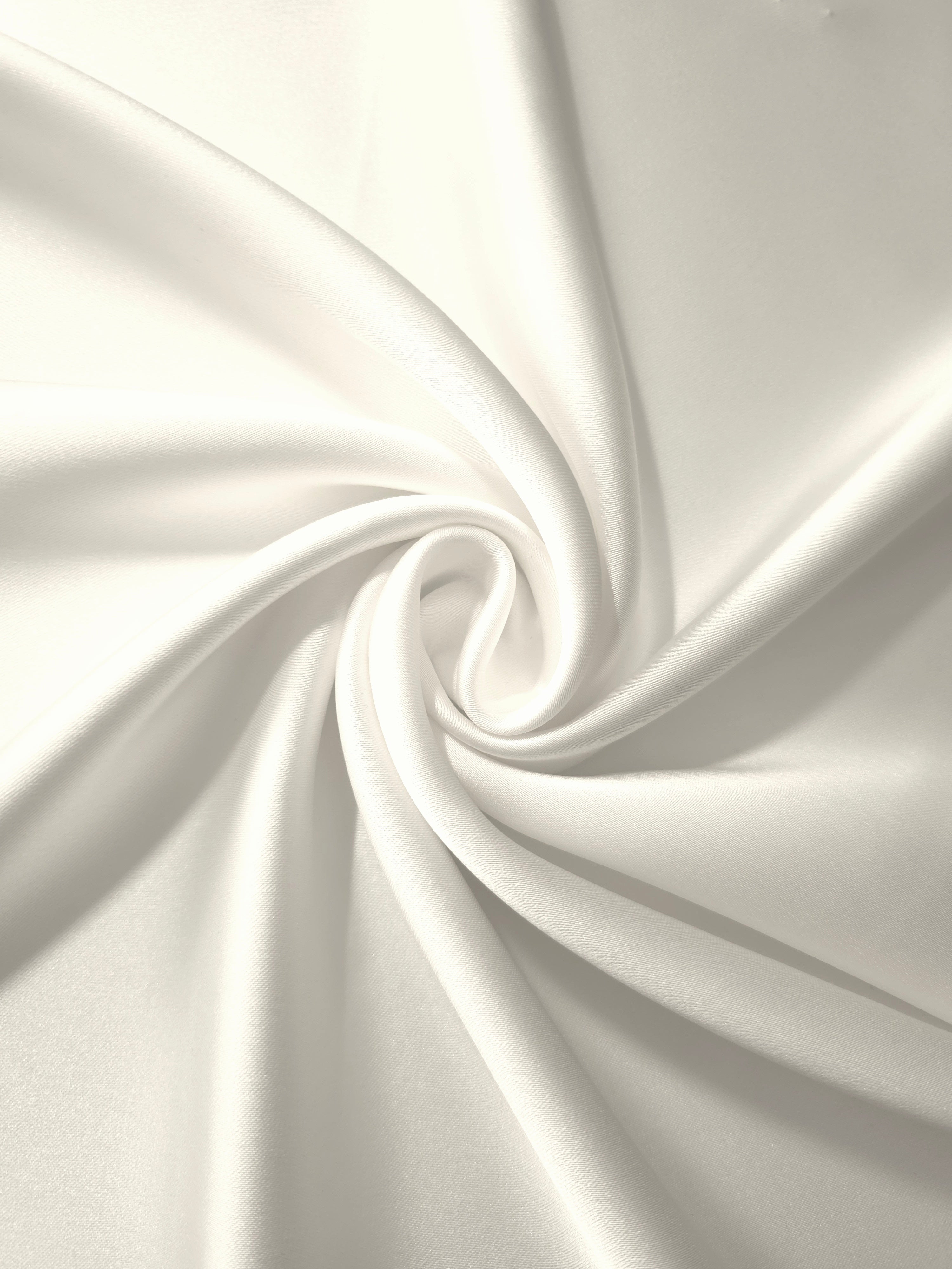 Twist-draped Cloud White silky satin shows how the fabric catches light in motion for wedding gowns, draped sleeves and elegant train details.
