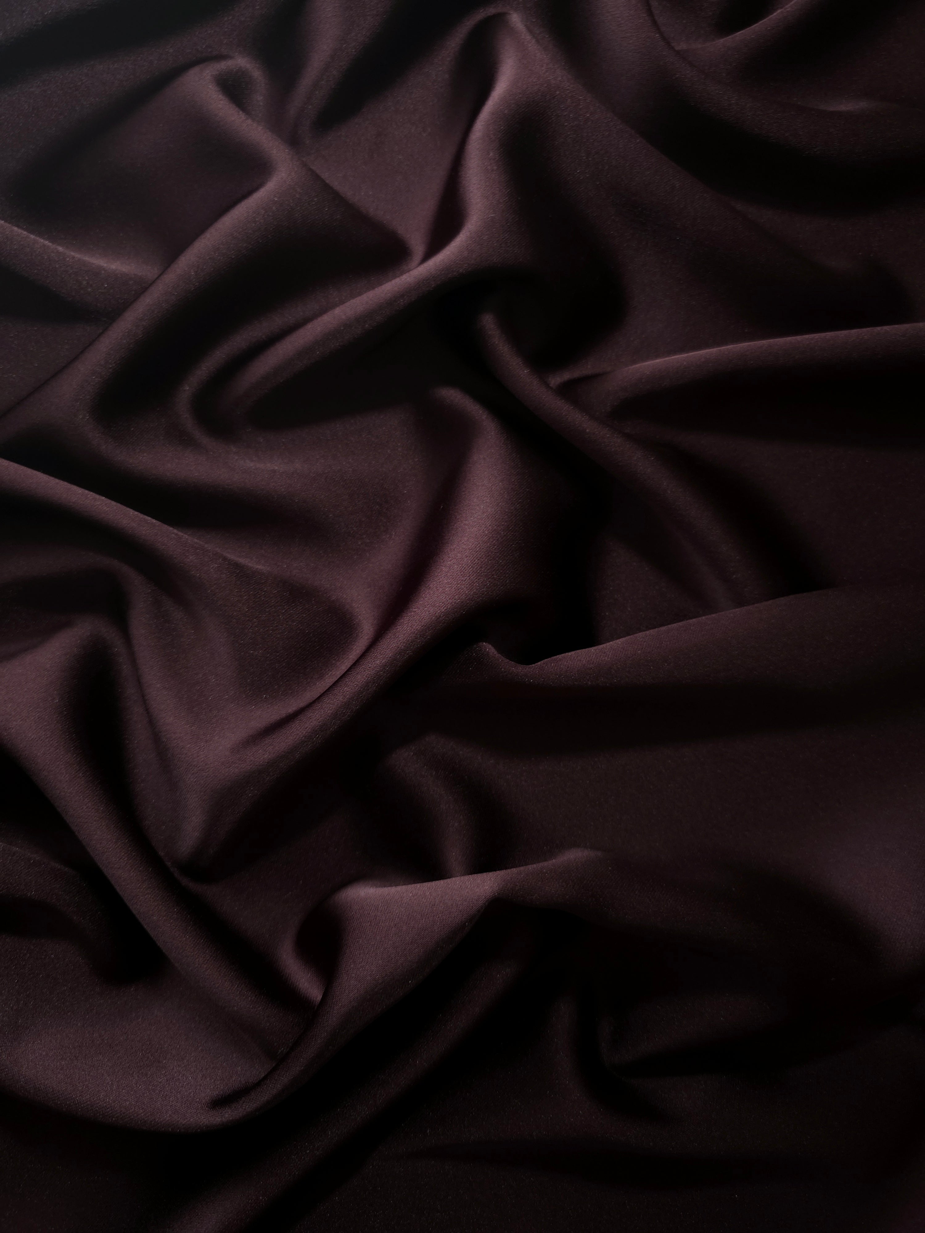 Deep Purple silky satin displayed in a rich flowing drape, combining glossy depth with fluid movement for evening gowns, gala dresses and statement skirts.