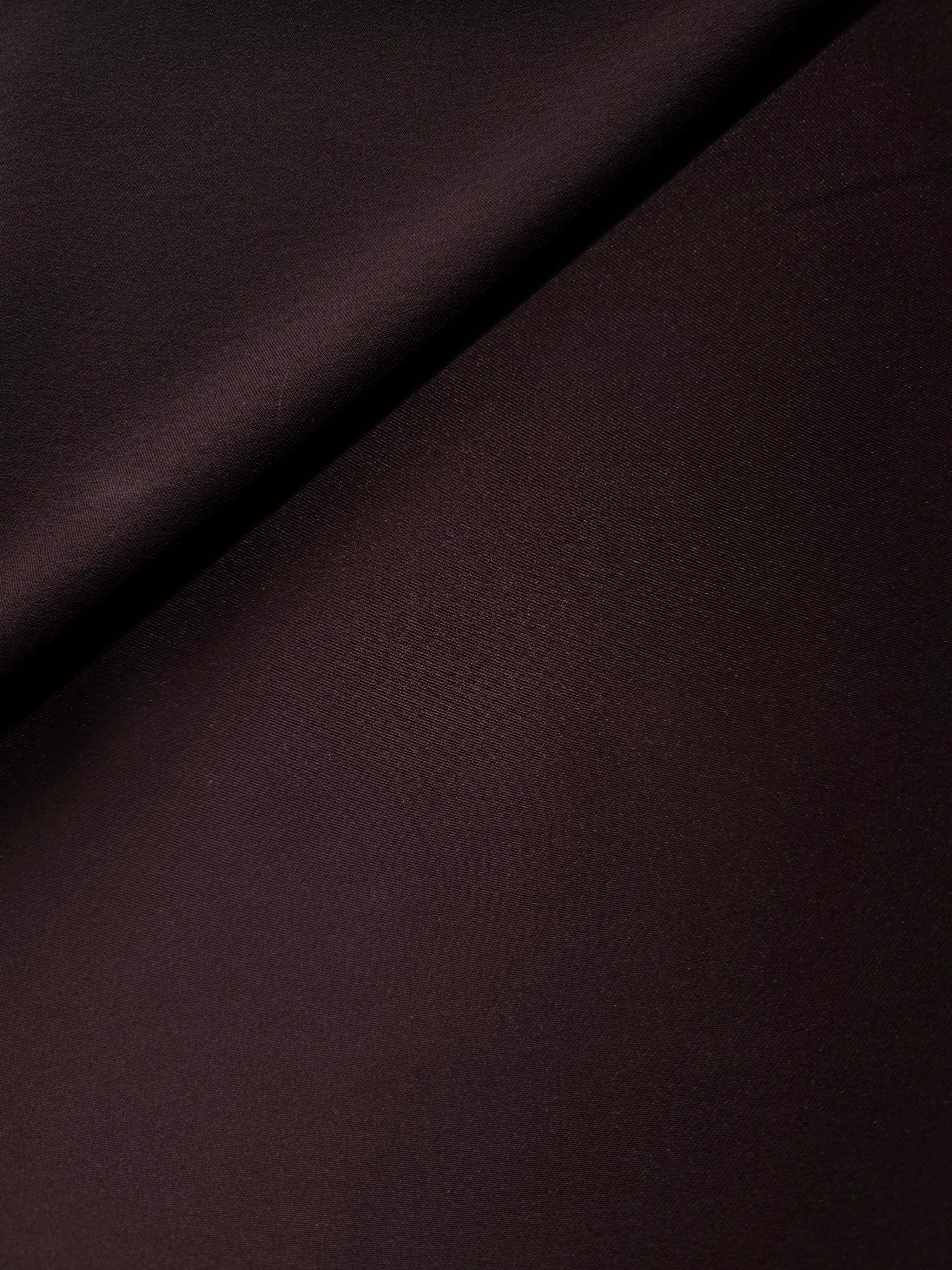 Deep Purple satin in layered folds reveals dramatic highlights and shadow for cocktail dresses, corset accents and theatrical fashion pieces.