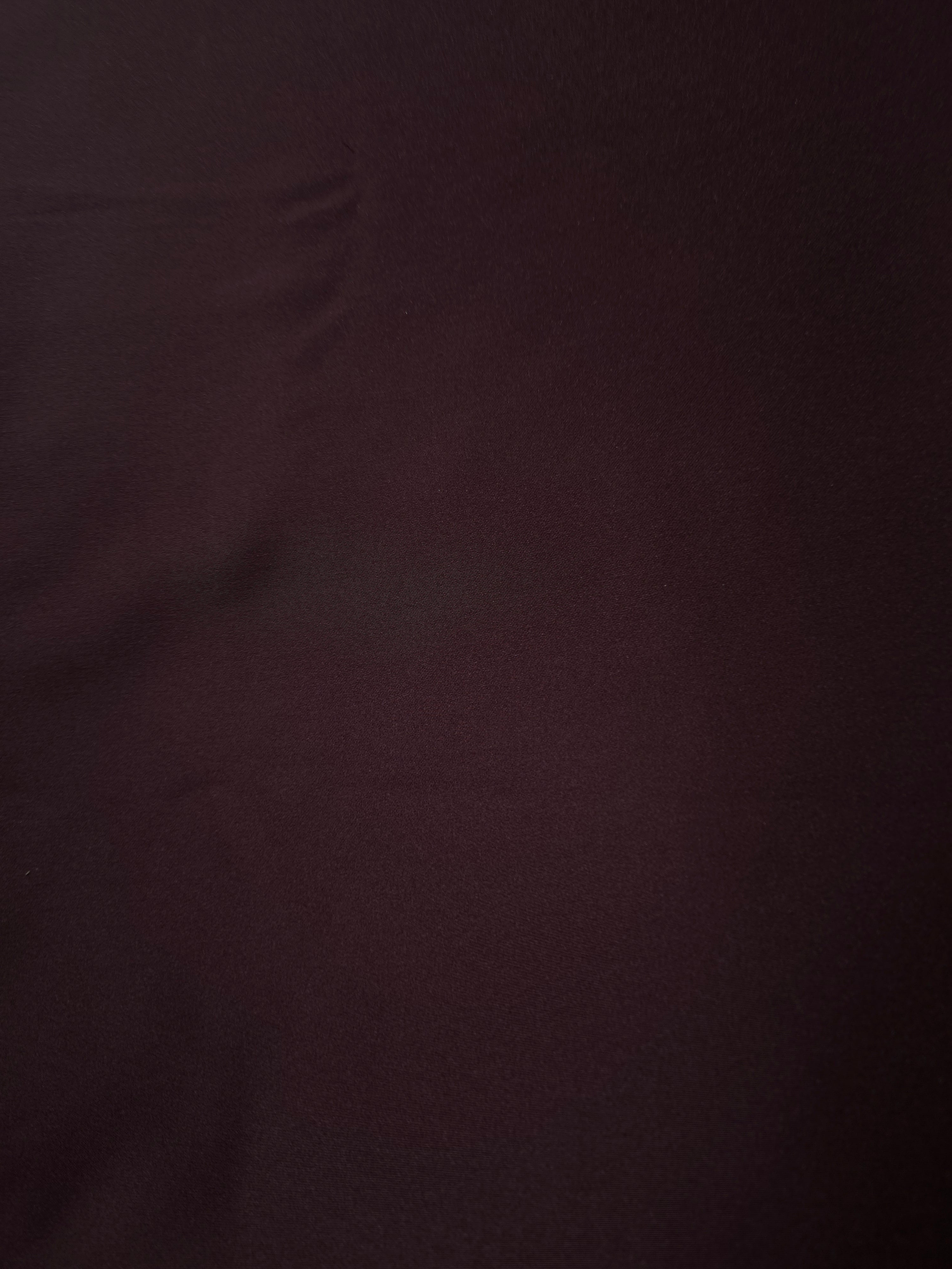 Close-up of Deep Purple silky satin emphasizes the smooth reflective face for blouse panels, evening tops and polished dress linings.