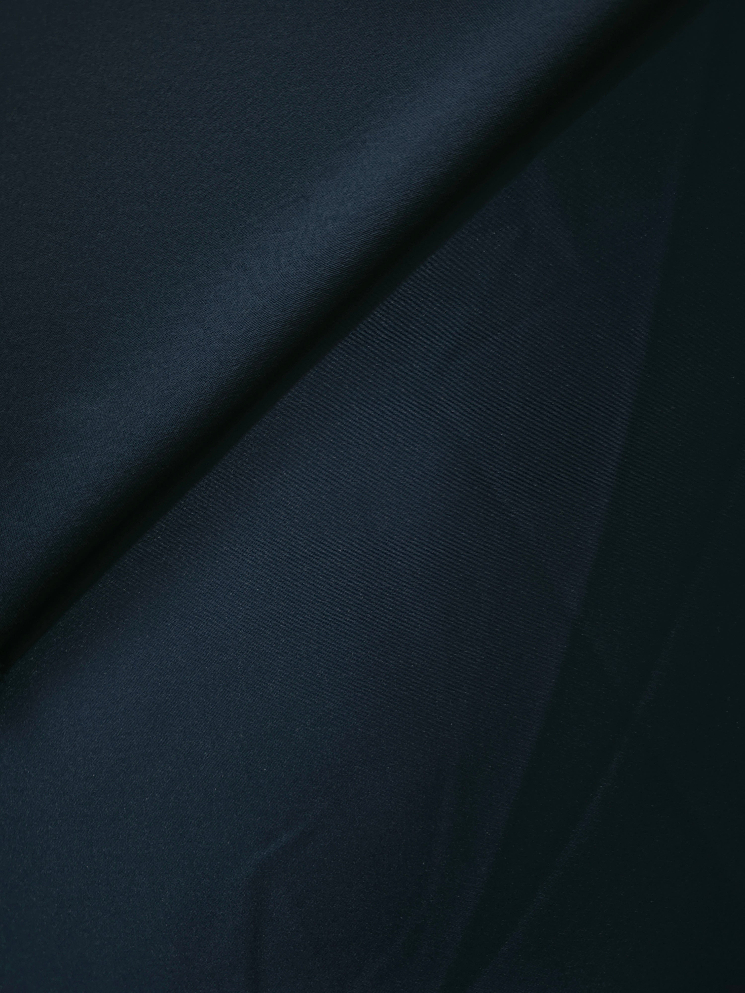 Royal Navy satin in fold detail reveals elegant light-and-shadow contrast for tuxedo-inspired accents, dress panels and structured evening pieces.