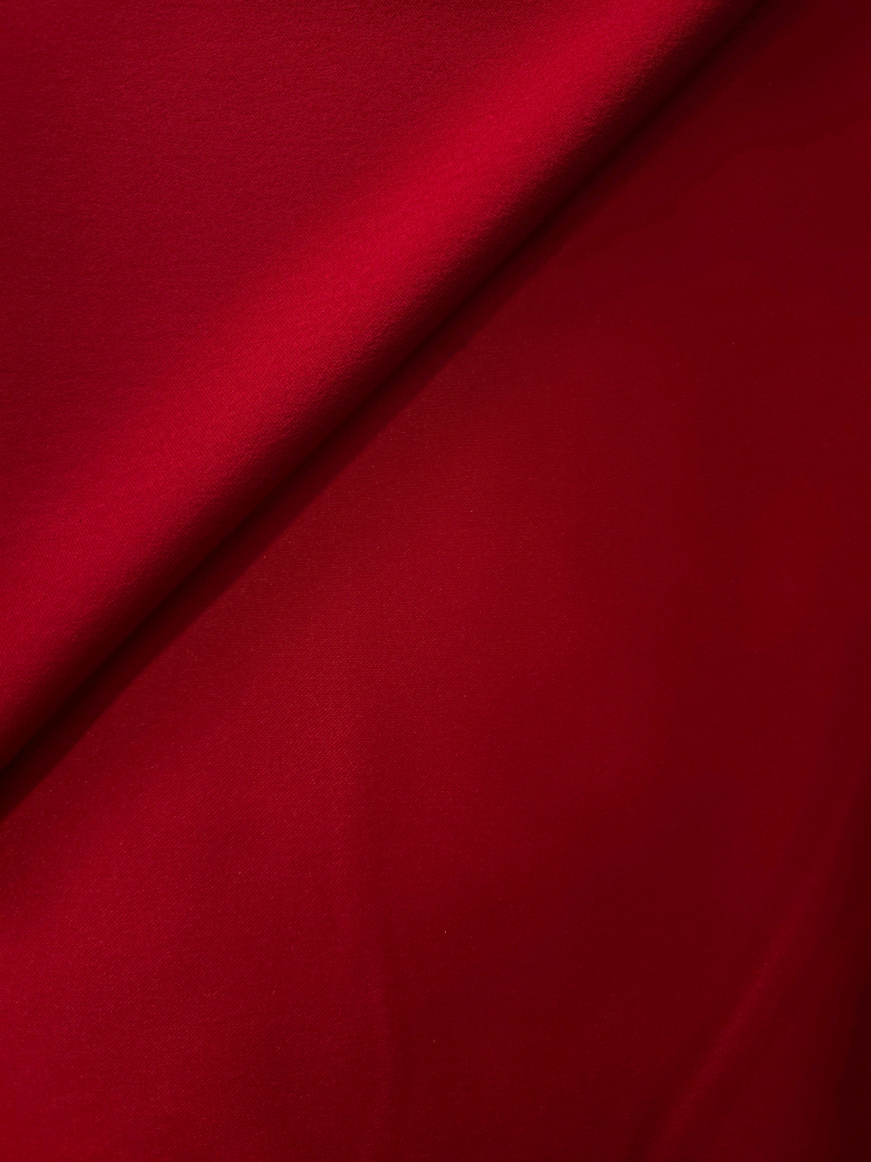 Folded Ruby Red satin shows intense highlights across the silky surface for fitted bodice details, cocktail skirts and statement dress panels.