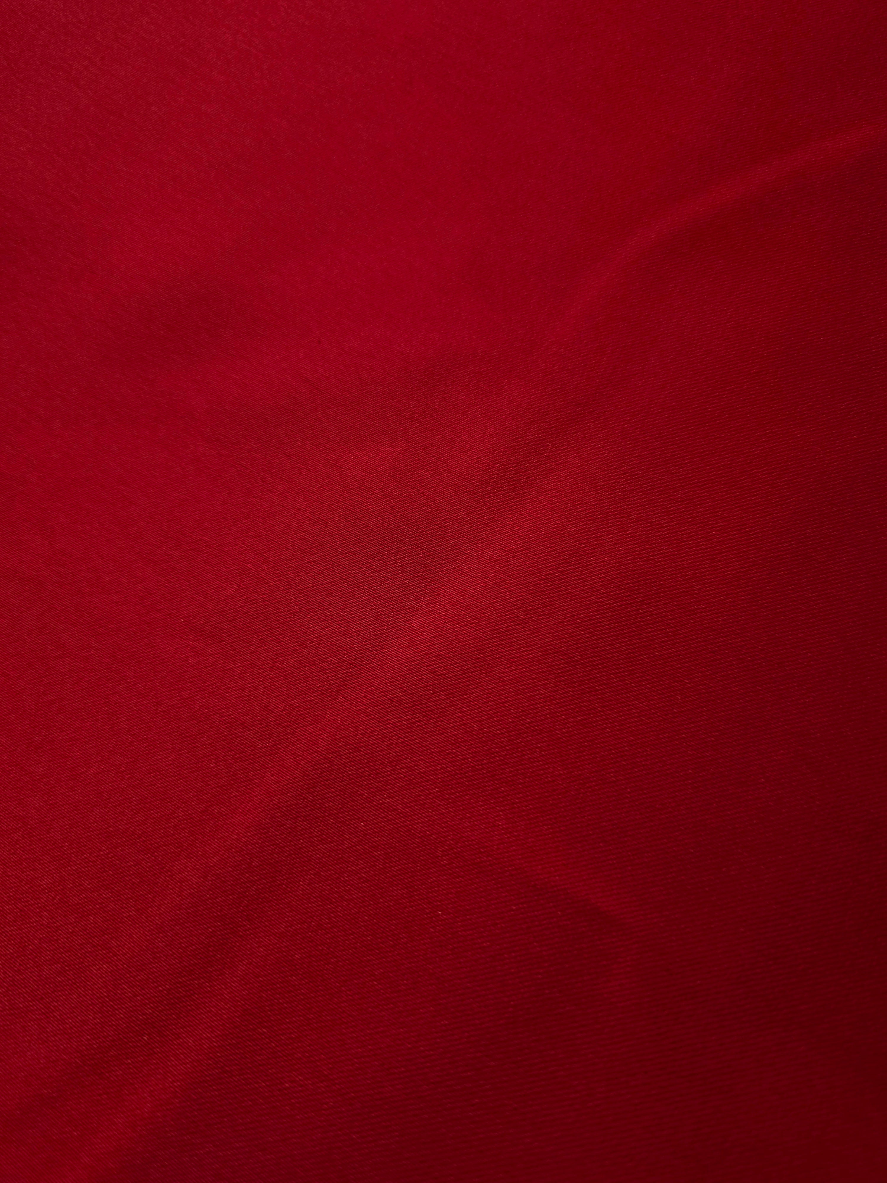Surface detail of Ruby Red satin highlights the smooth glossy face for scarves, bows, festive accessories and dramatic decorative accents.