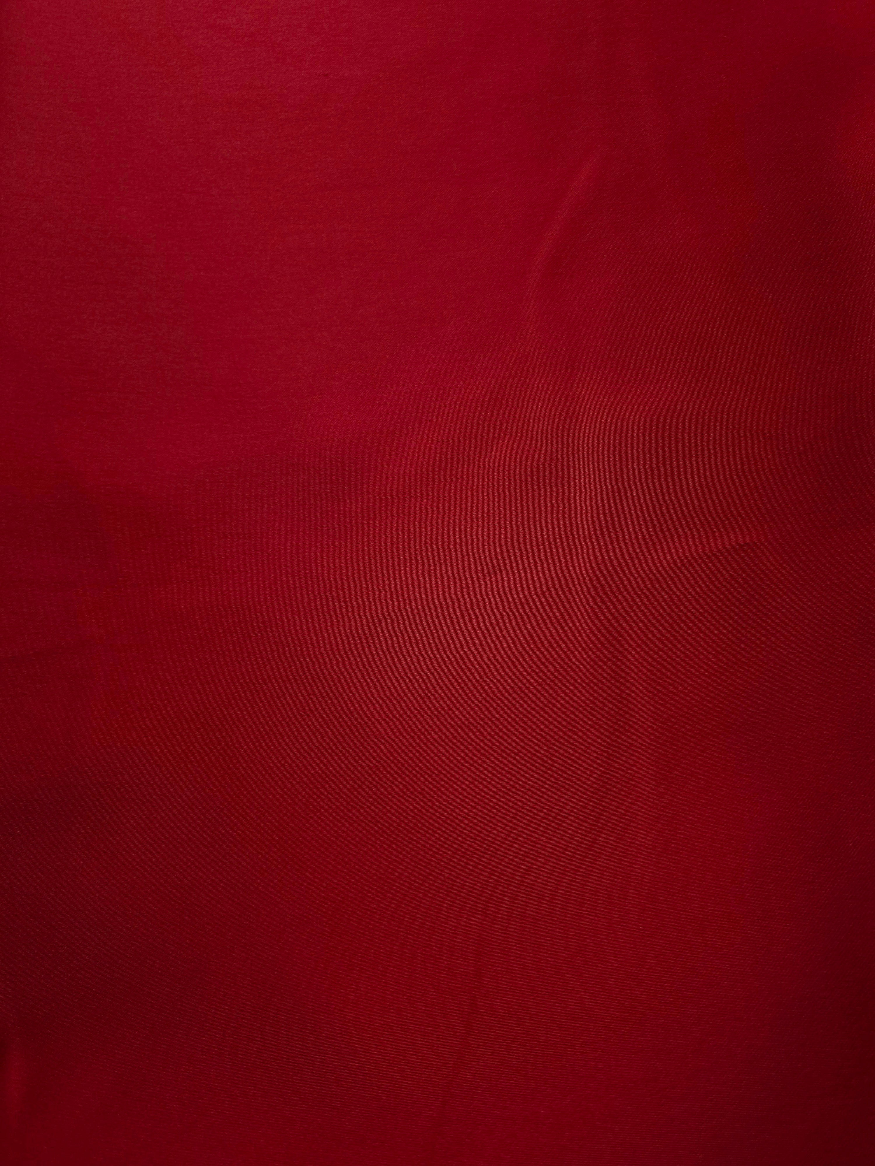 Close-up of Ruby Red silky satin shows an even lustrous texture for blouses, camisoles and polished lining applications.