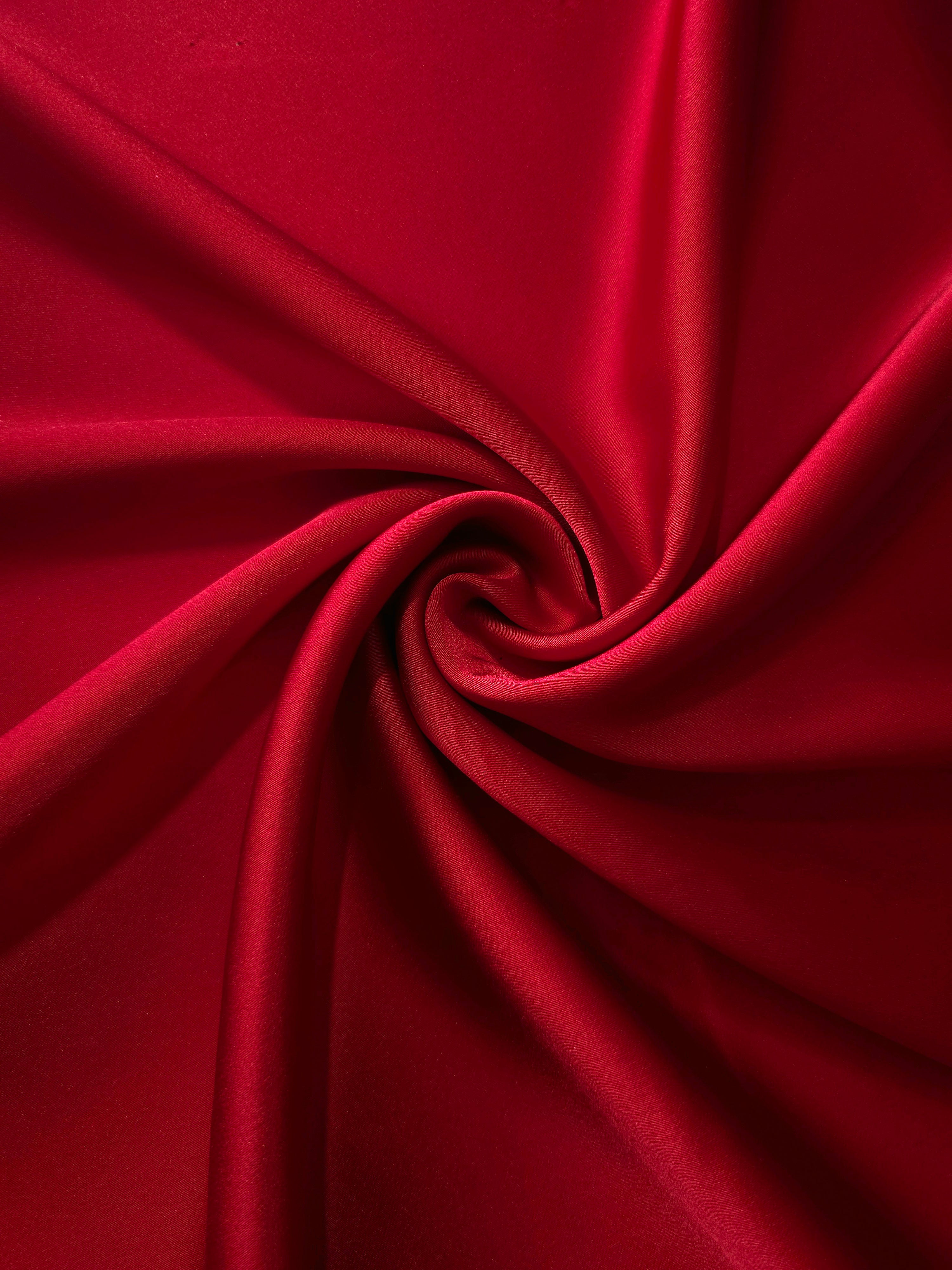 Twisted Ruby Red satin creates bold reflective curves for prom gowns, draped dresses and performance costumes designed to catch stage light.