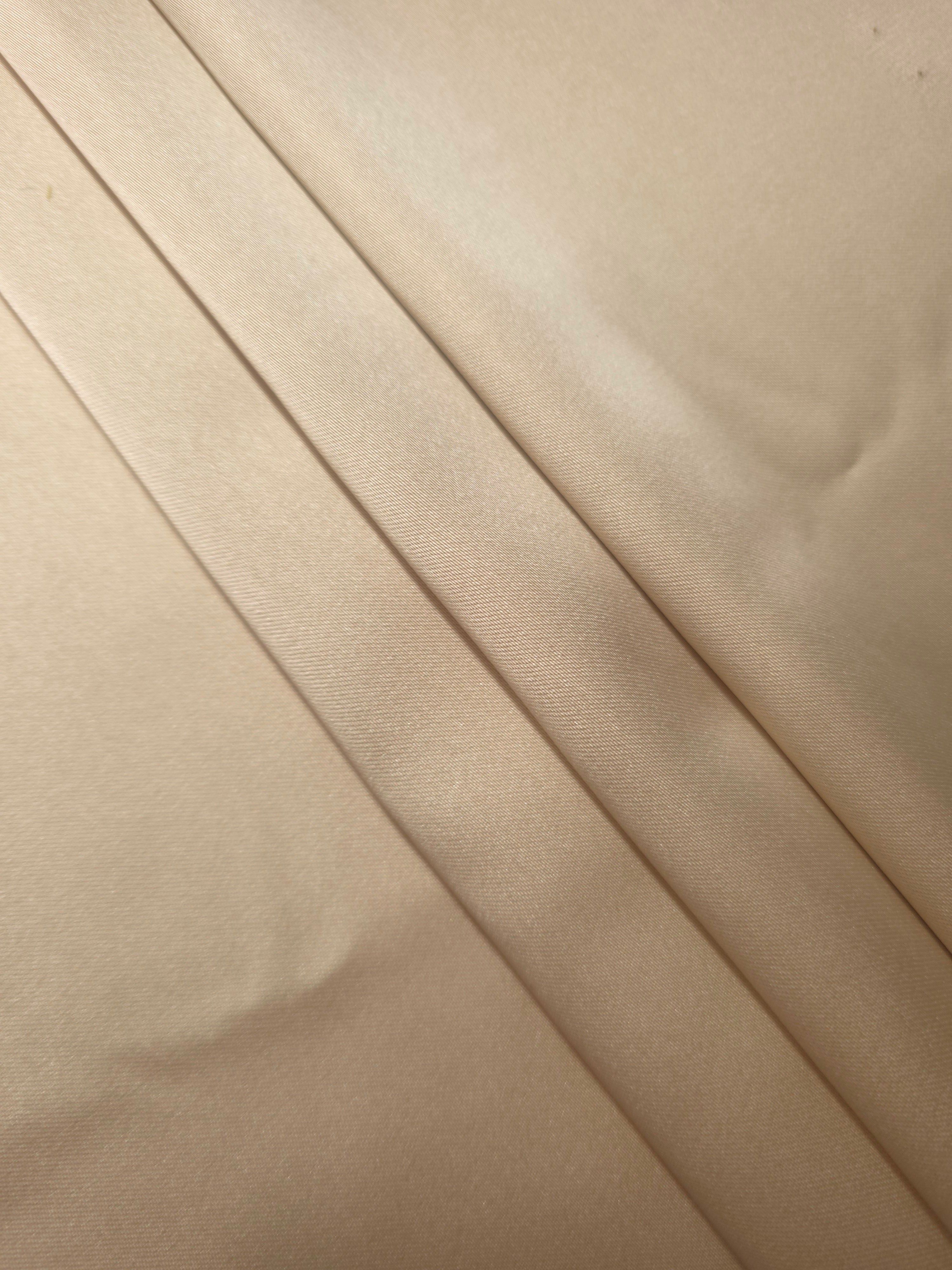Warm Nude silky satin gathered into soft folds, showing a fluid fall for slip dresses, robes and understated luxury loungewear.