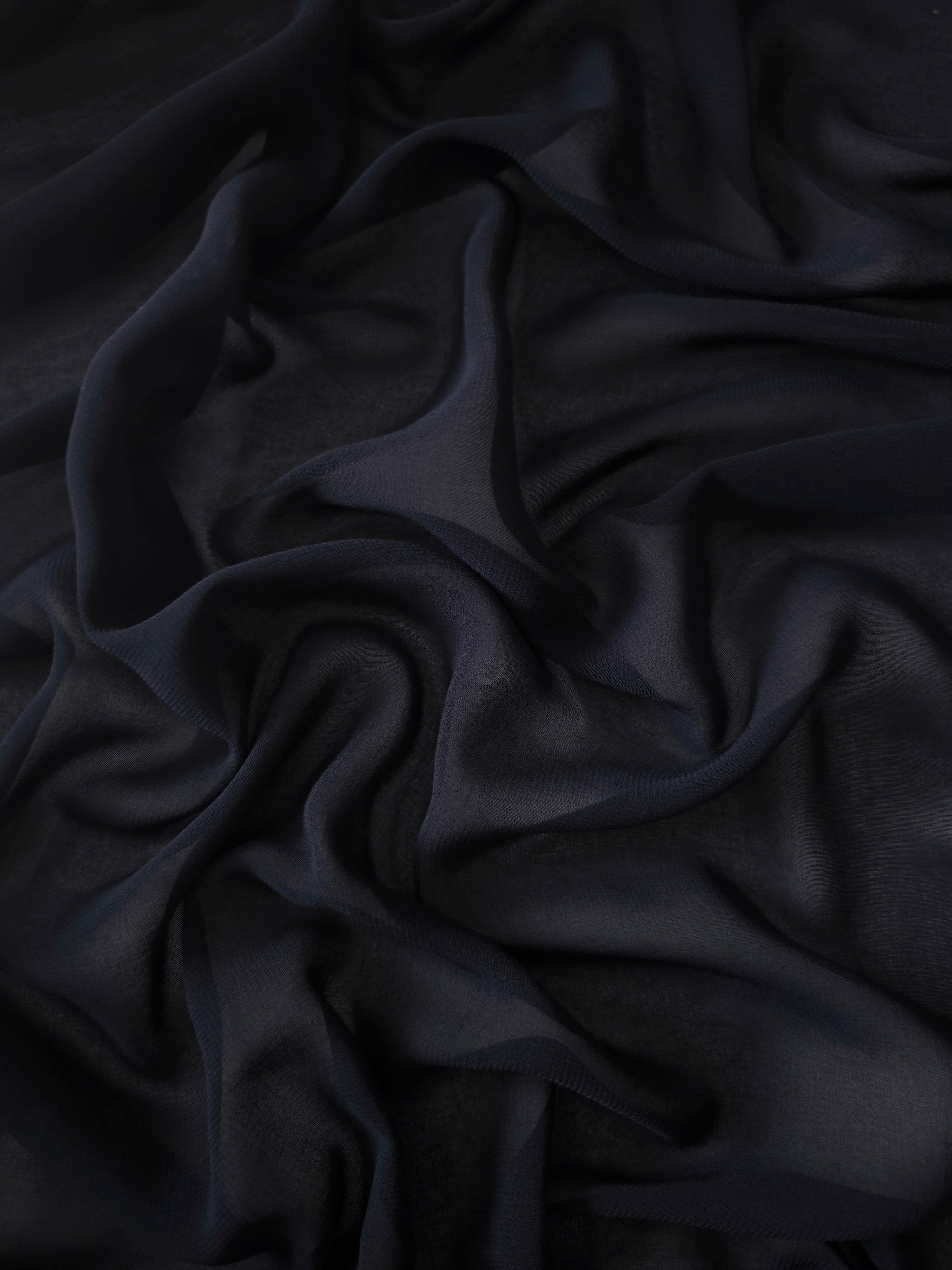 Blackened Navy stretch chiffon arranged in long draped folds to show movement for flowing evening skirts, gowns and layered formal looks.