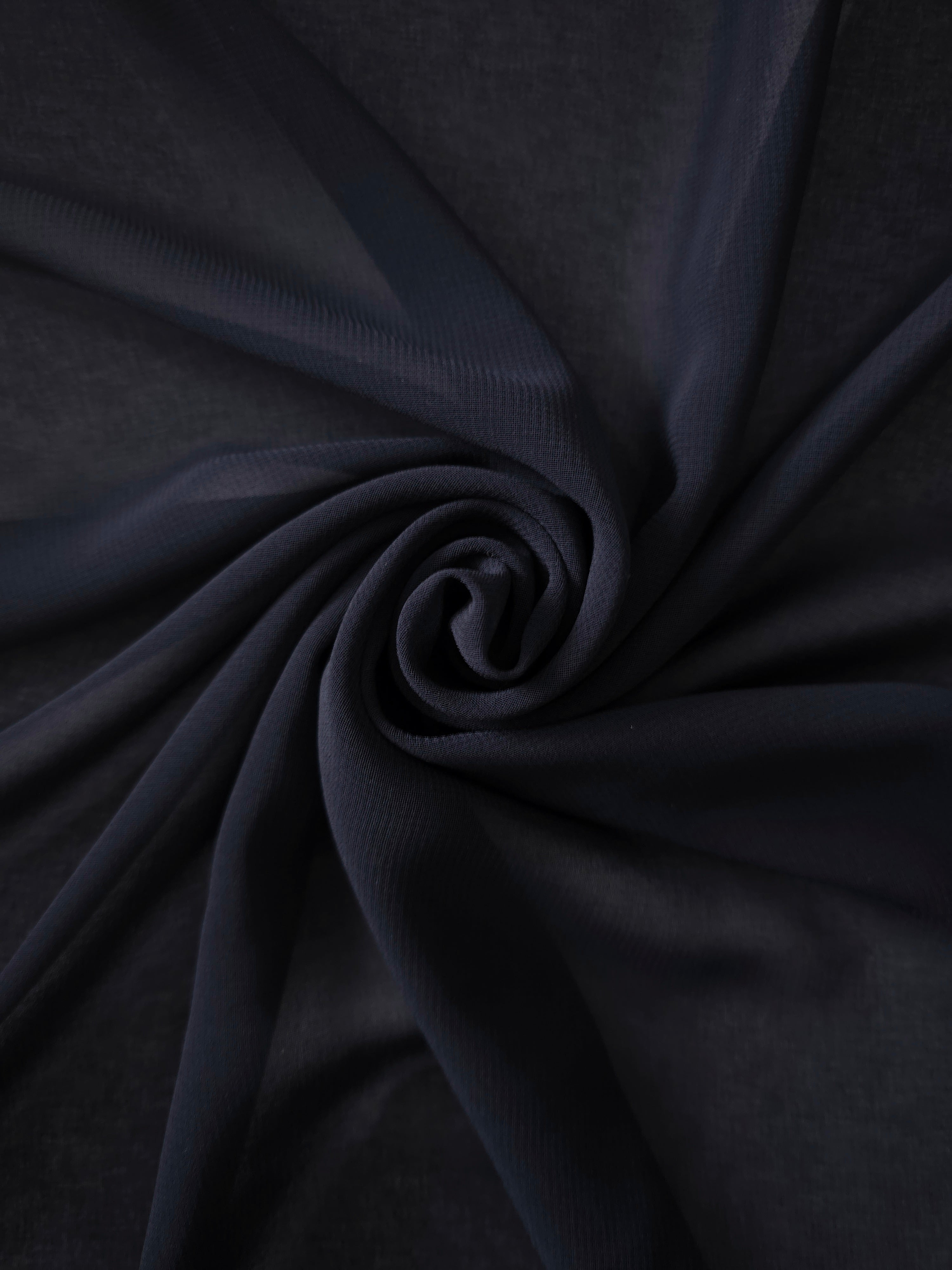 Swirled Blackened Navy silky stretch chiffon shows soft motion and fluid drape for shawls, gathered dress panels and sophisticated draped accents.