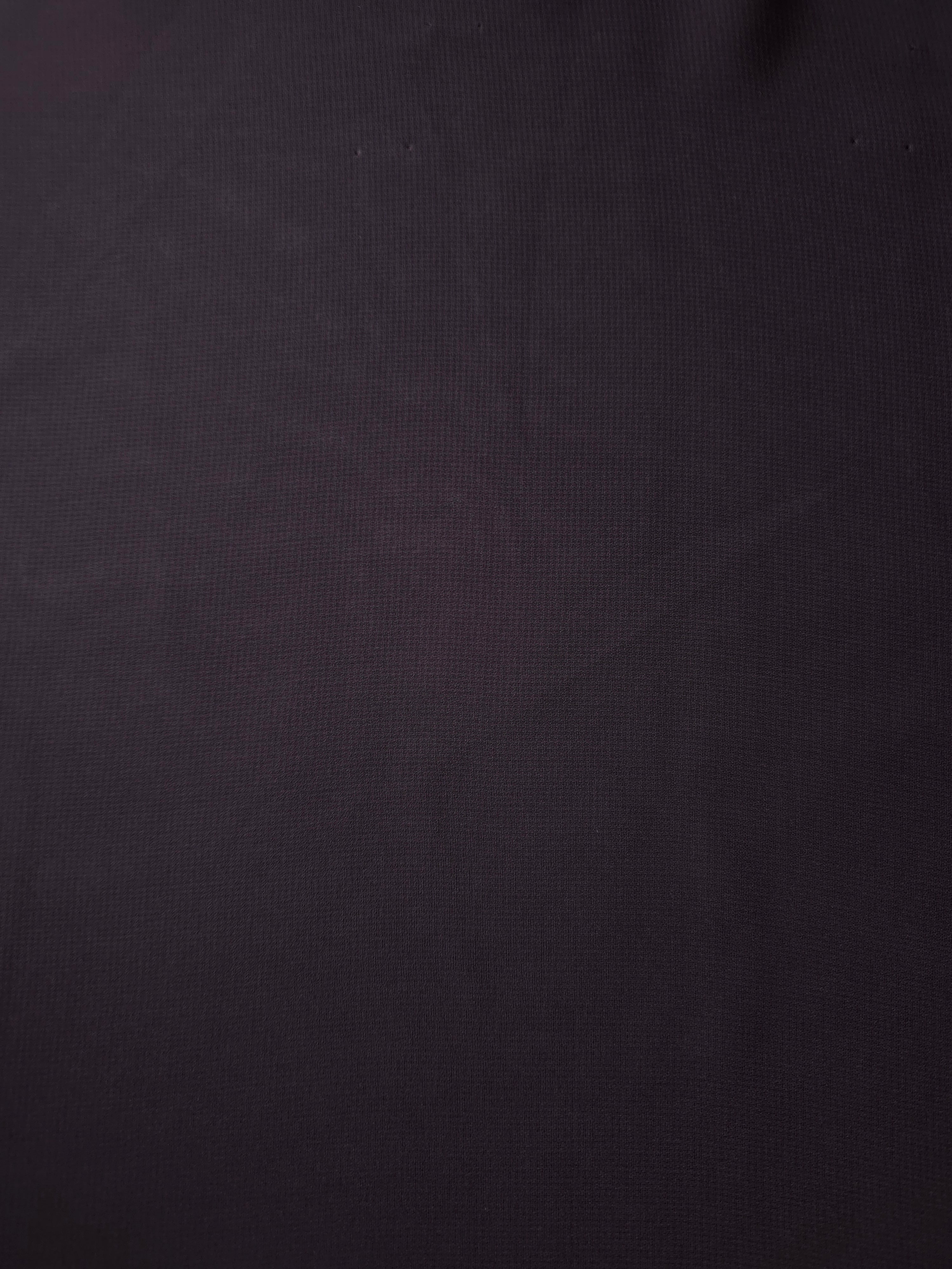 Full surface of Charcoal Mauve silky chiffon stretch fabric, presenting a light flowing base for modern blouses, formal skirts and muted sheer overlays.