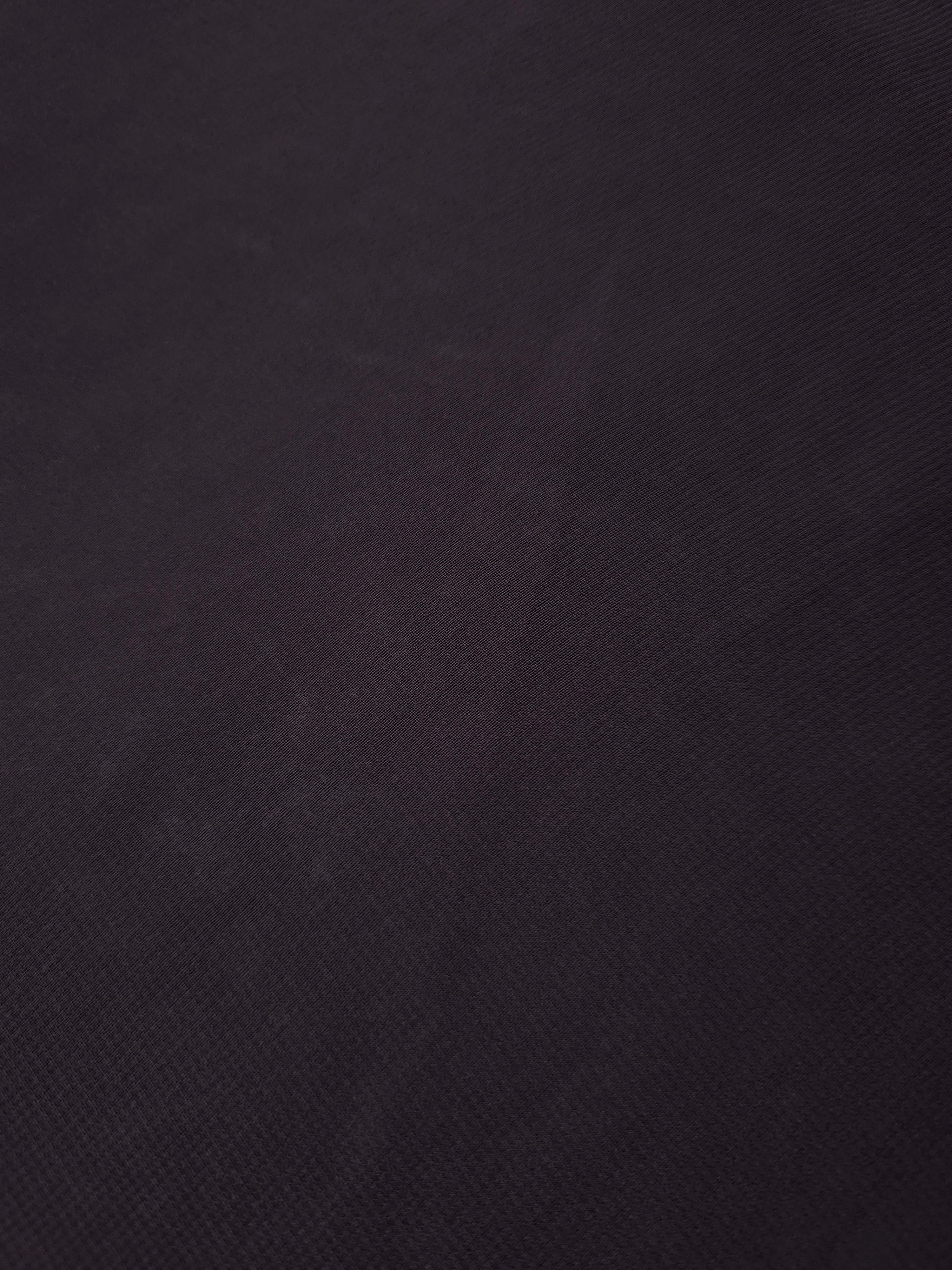 Texture view of Charcoal Mauve stretch chiffon, capturing the fine sheer character used for transparent sleeves, neckline details and soft scarf panels.