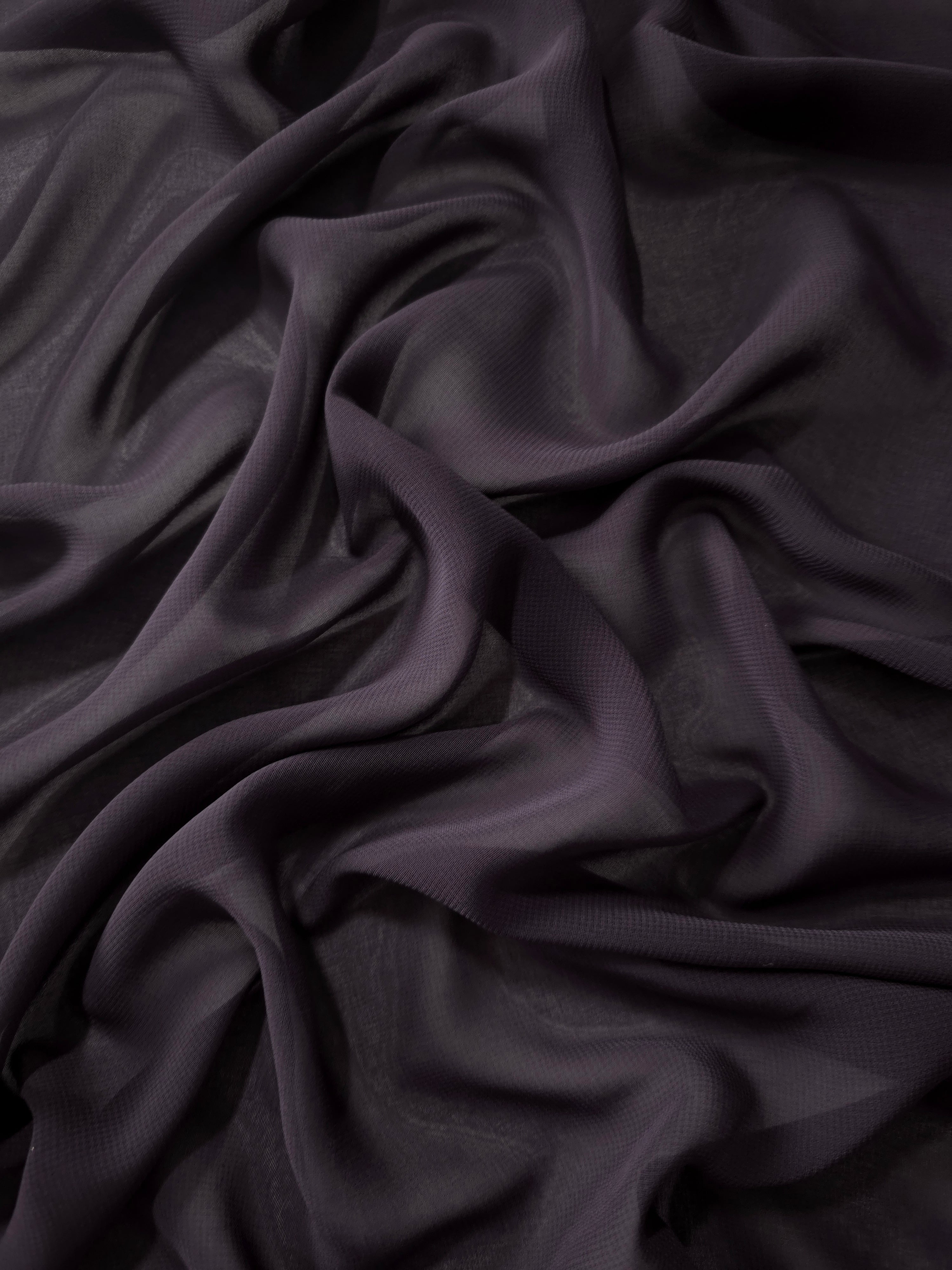Charcoal Mauve silky chiffon stretch fabric in cascading folds, showing fluidity for flowing gowns, layered skirts and understated occasionwear.