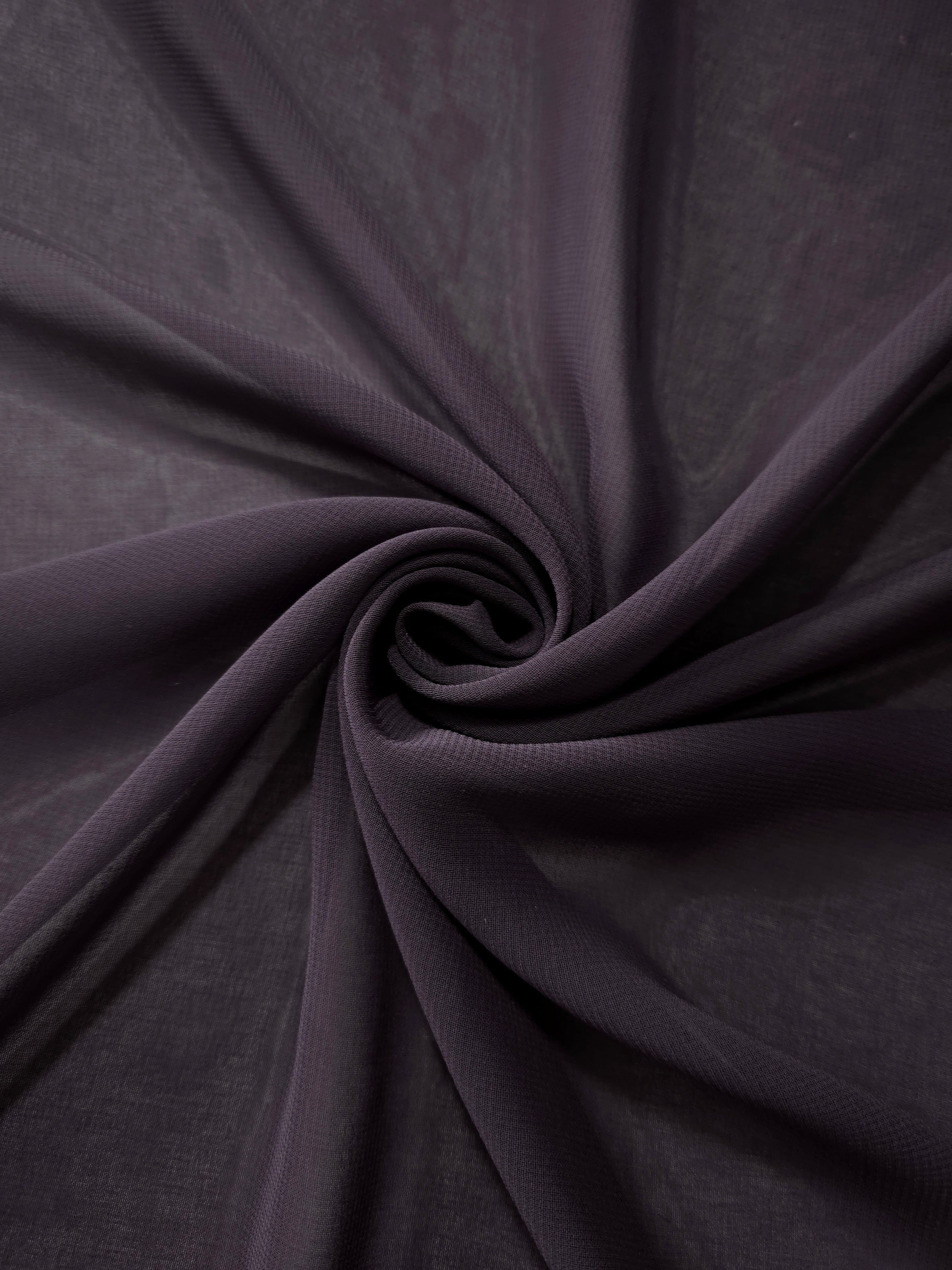 Charcoal Mauve silky chiffon stretch fabric styled in a swirl to demonstrate movement for scarves, gathered extensions and softly draped dress accents.