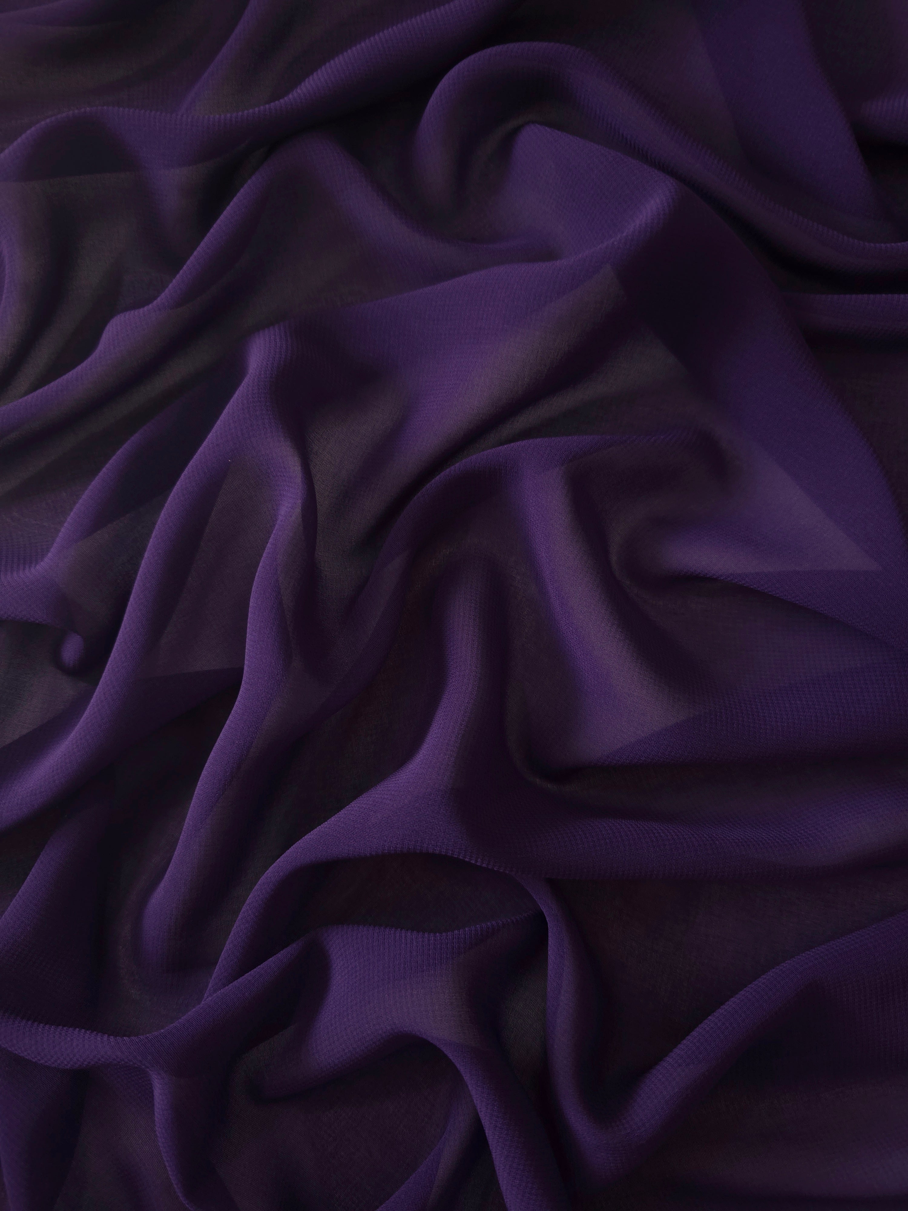 Draped Deep Aubergine silky stretch chiffon with flowing folds, ideal for evening gowns, bridesmaid dresses and flowing maxi skirts.