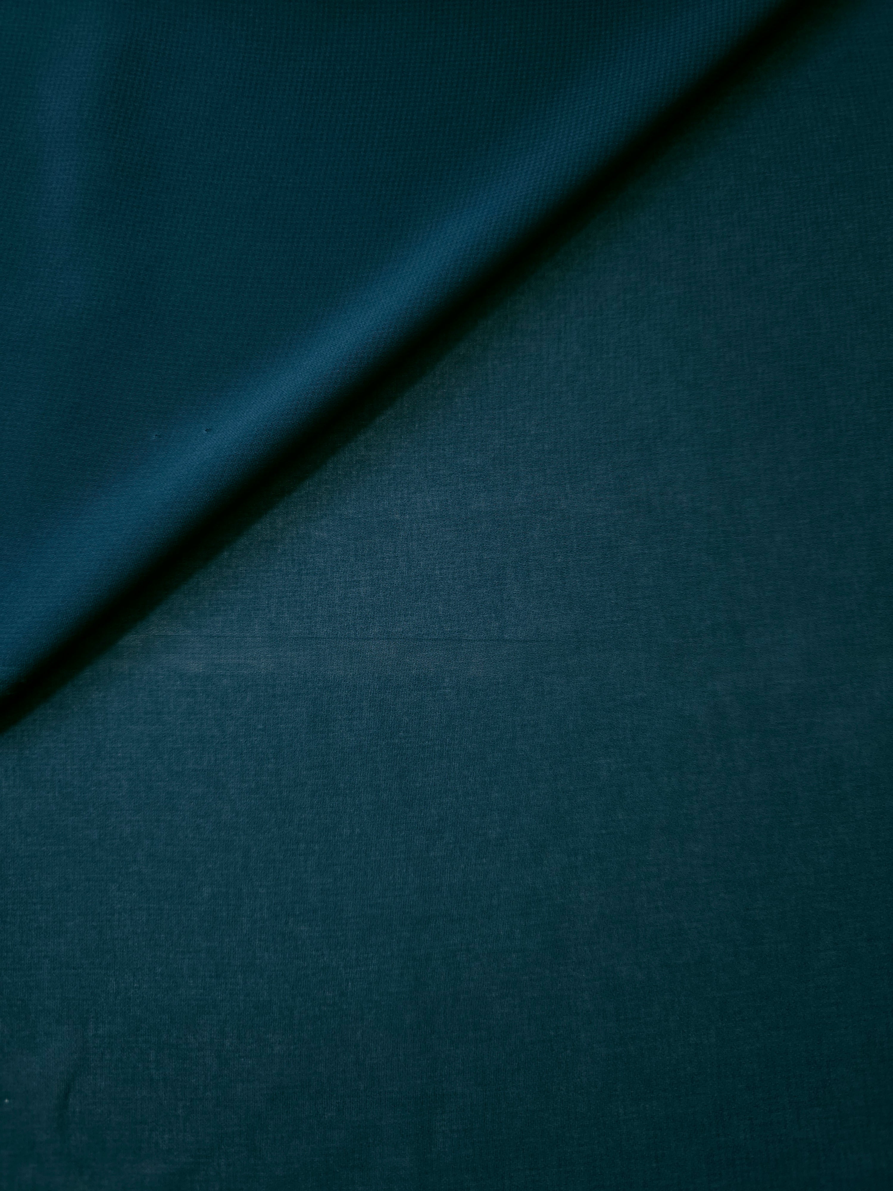 Deep Petrol Teal silky stretch chiffon stacked in soft layers, revealing airy volume for tiered skirts, cape overlays and dimensional teal garments.