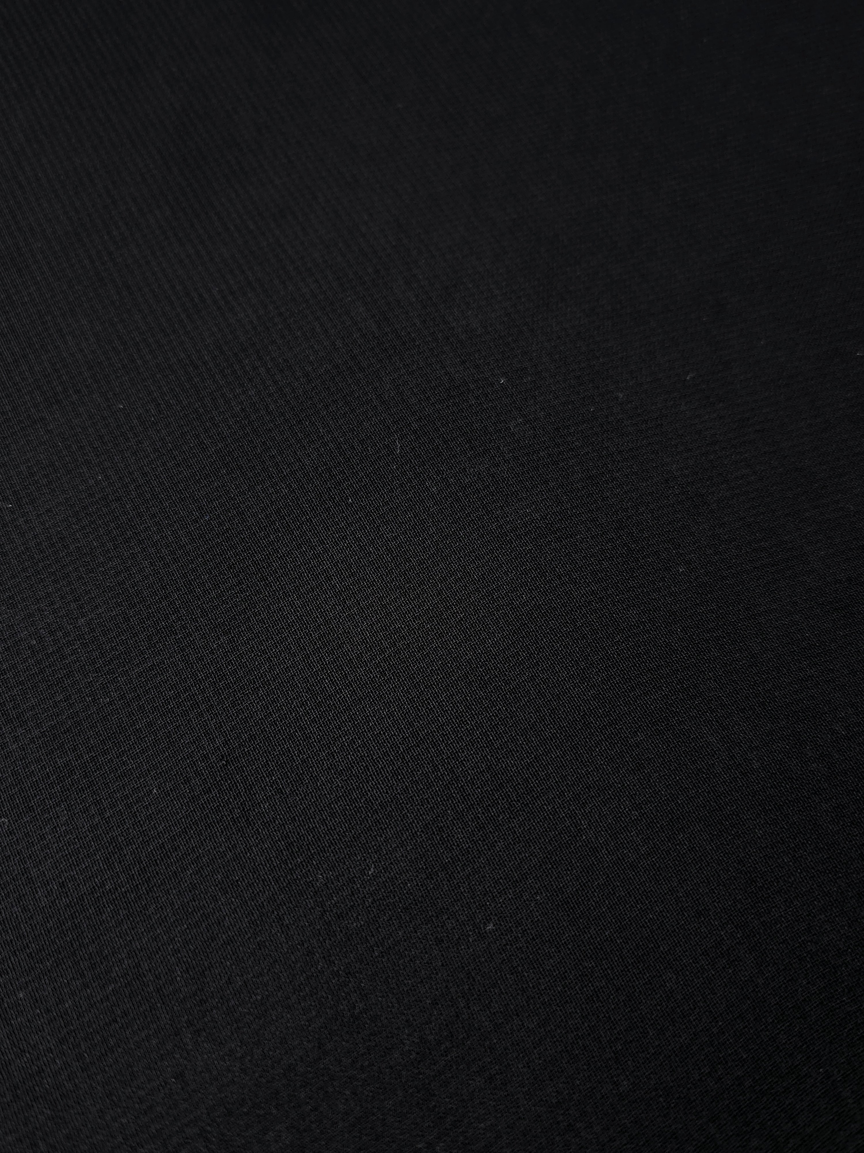 Jet Black silky stretch chiffon softly folded to display drape suited to cocktail dresses, flowing blouses and lightweight scarves.