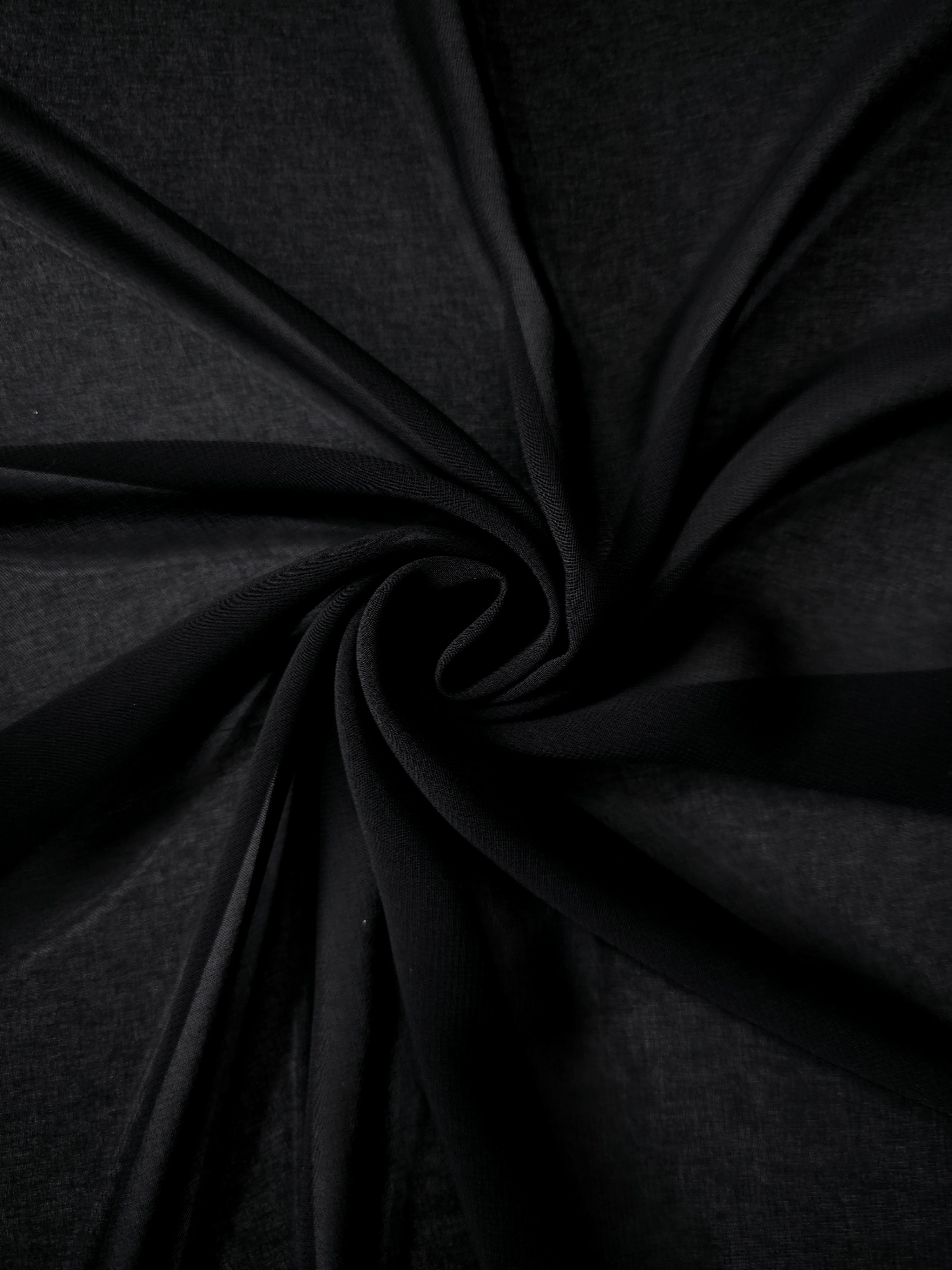 Jet Black silky chiffon stretch fabric in cascading folds, showing fluidity for formal gowns, costume layers and fluid evening skirts.