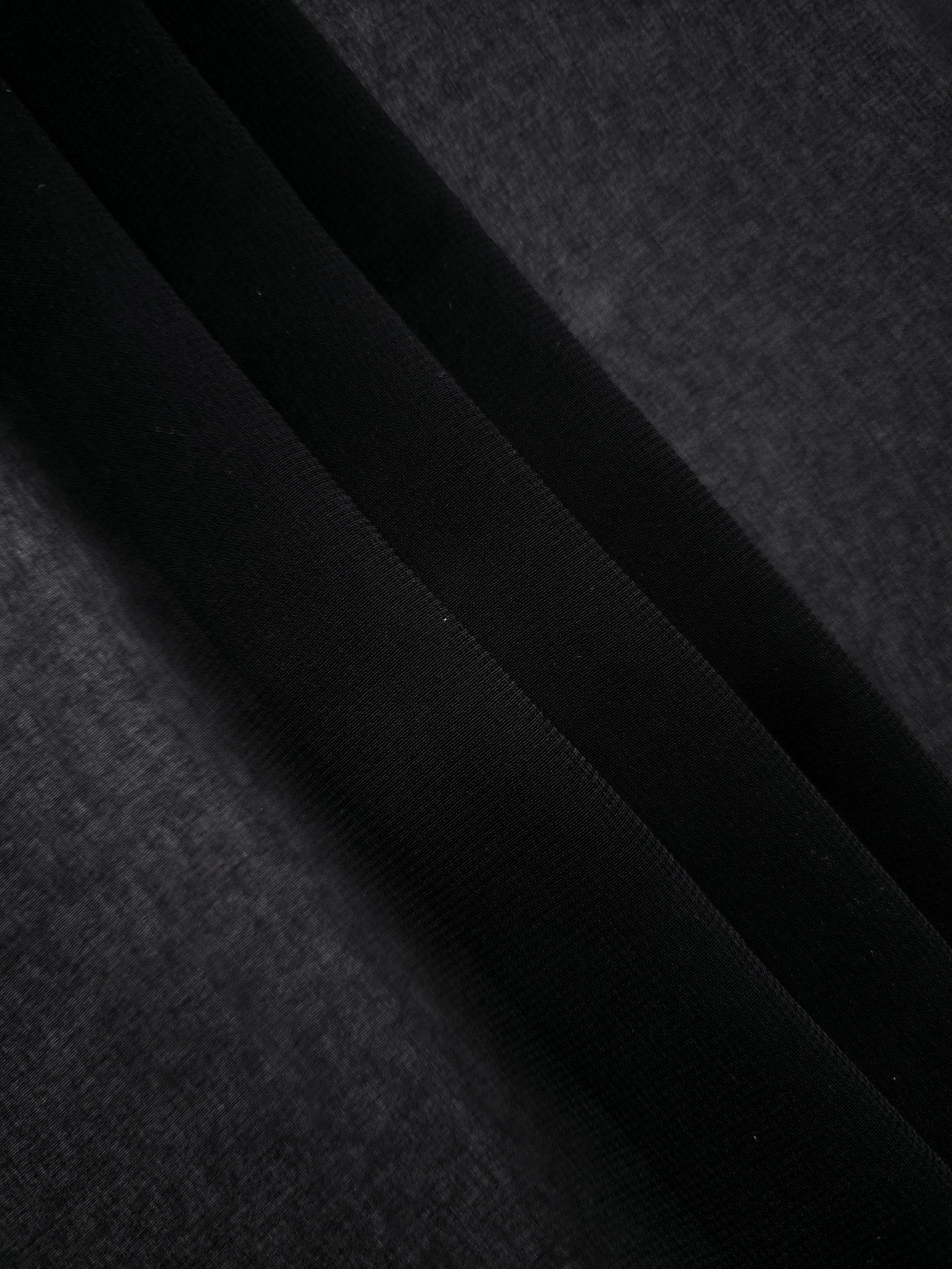 Jet Black stretch chiffon in overlapping folds, showing dimensional drape for tiered black skirts, layered dresses and elegant cape details.