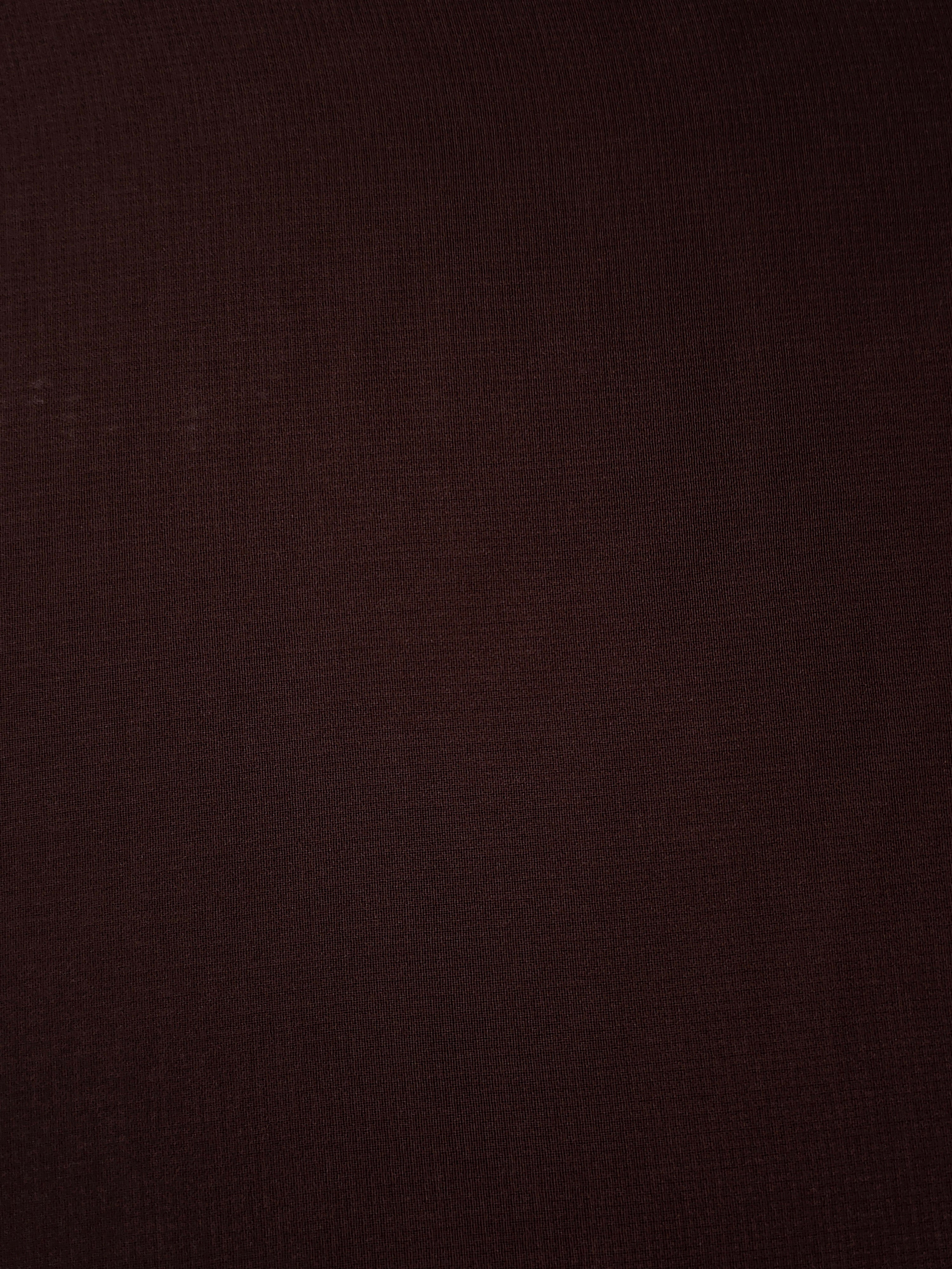 Close-up of Mahogany Brown stretch chiffon revealing fine texture and translucency for sheer sleeves, ruffles and refined neckline inserts.