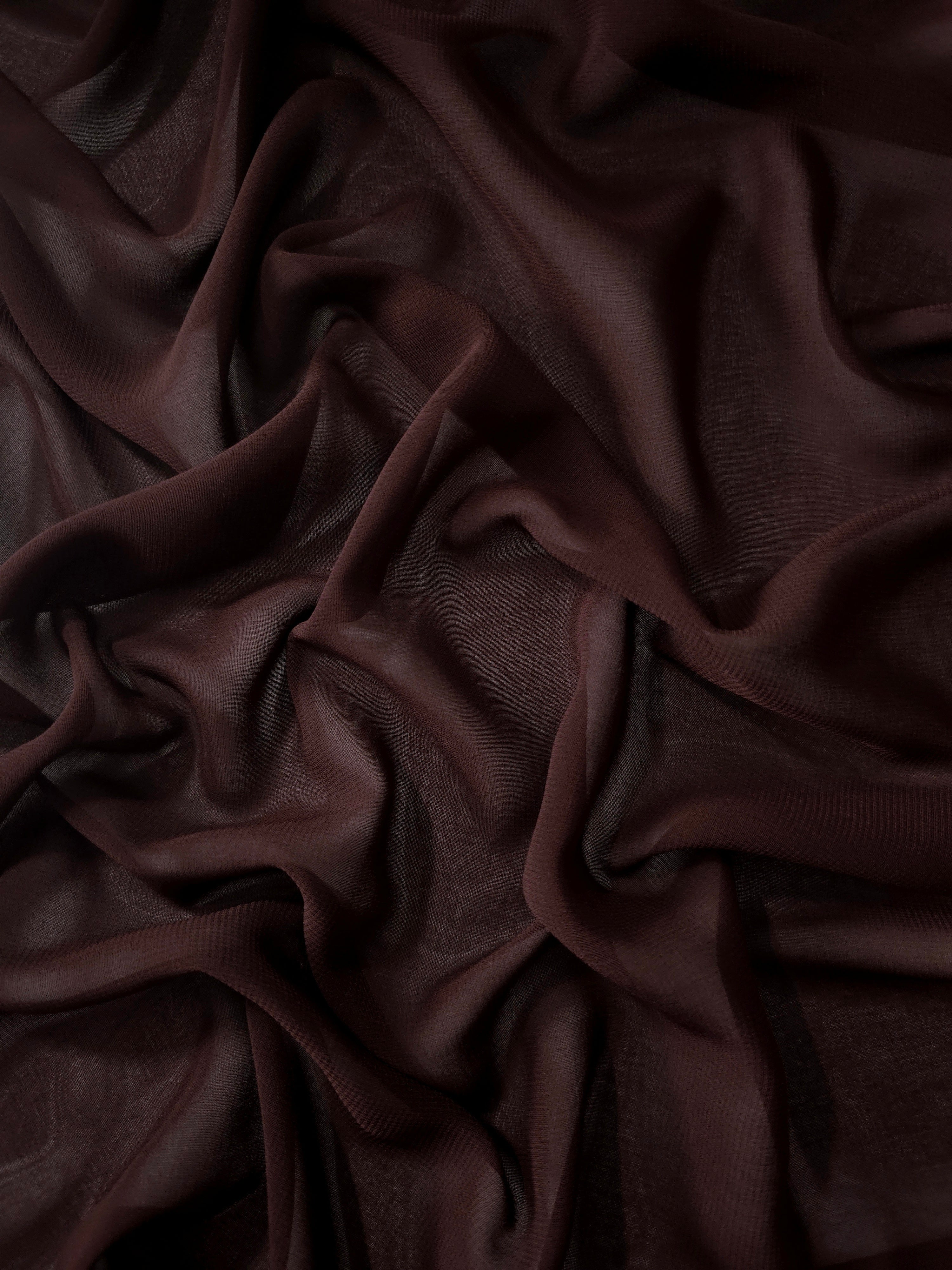 Draped Mahogany Brown silky stretch chiffon with flowing folds, ideal for formal gowns, flowing skirts and rich layered looks.