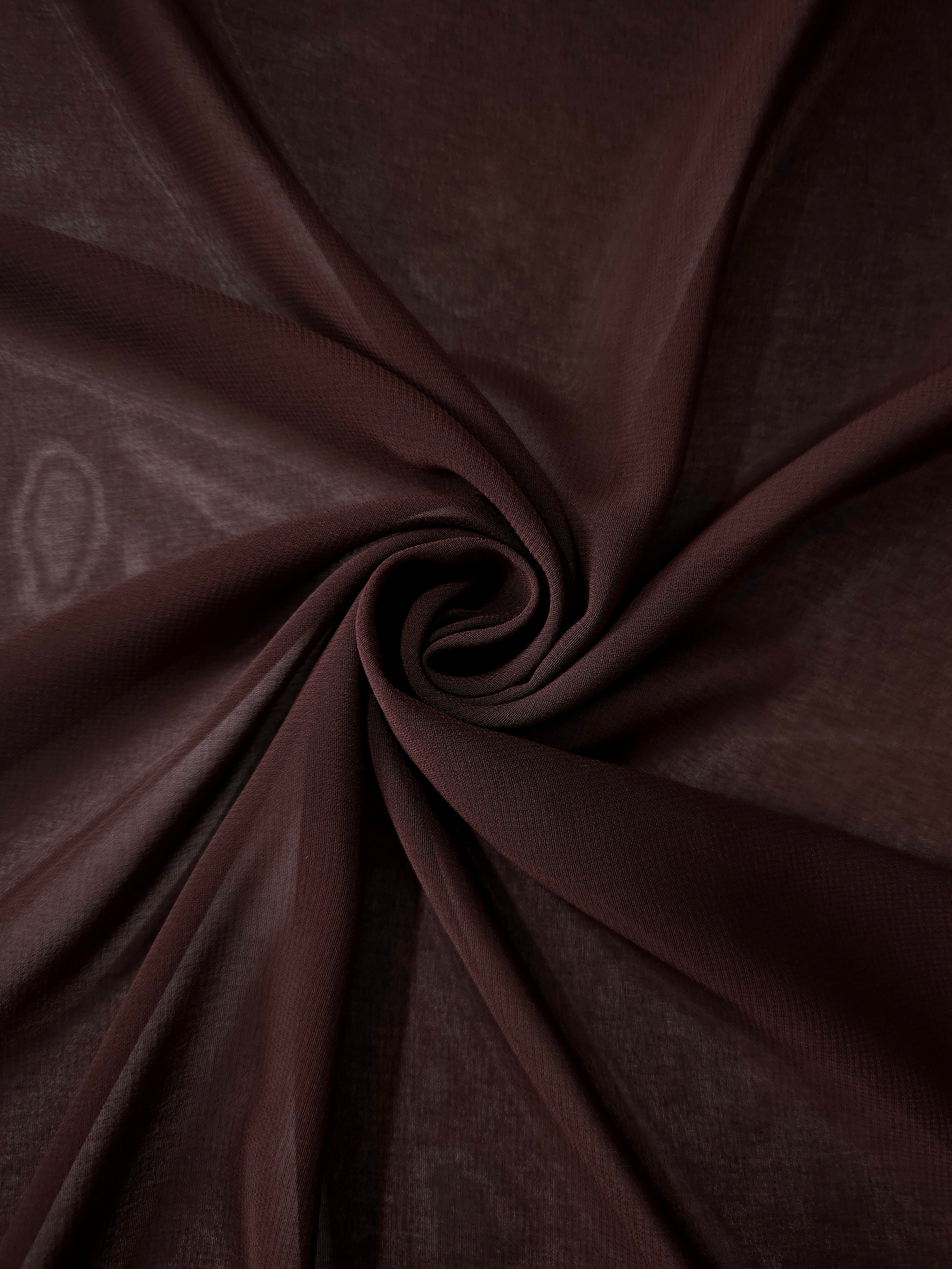 Mahogany Brown stretch chiffon arranged in a swirl, emphasizing airy movement for shawls, gathered panels and elegant dress extensions.