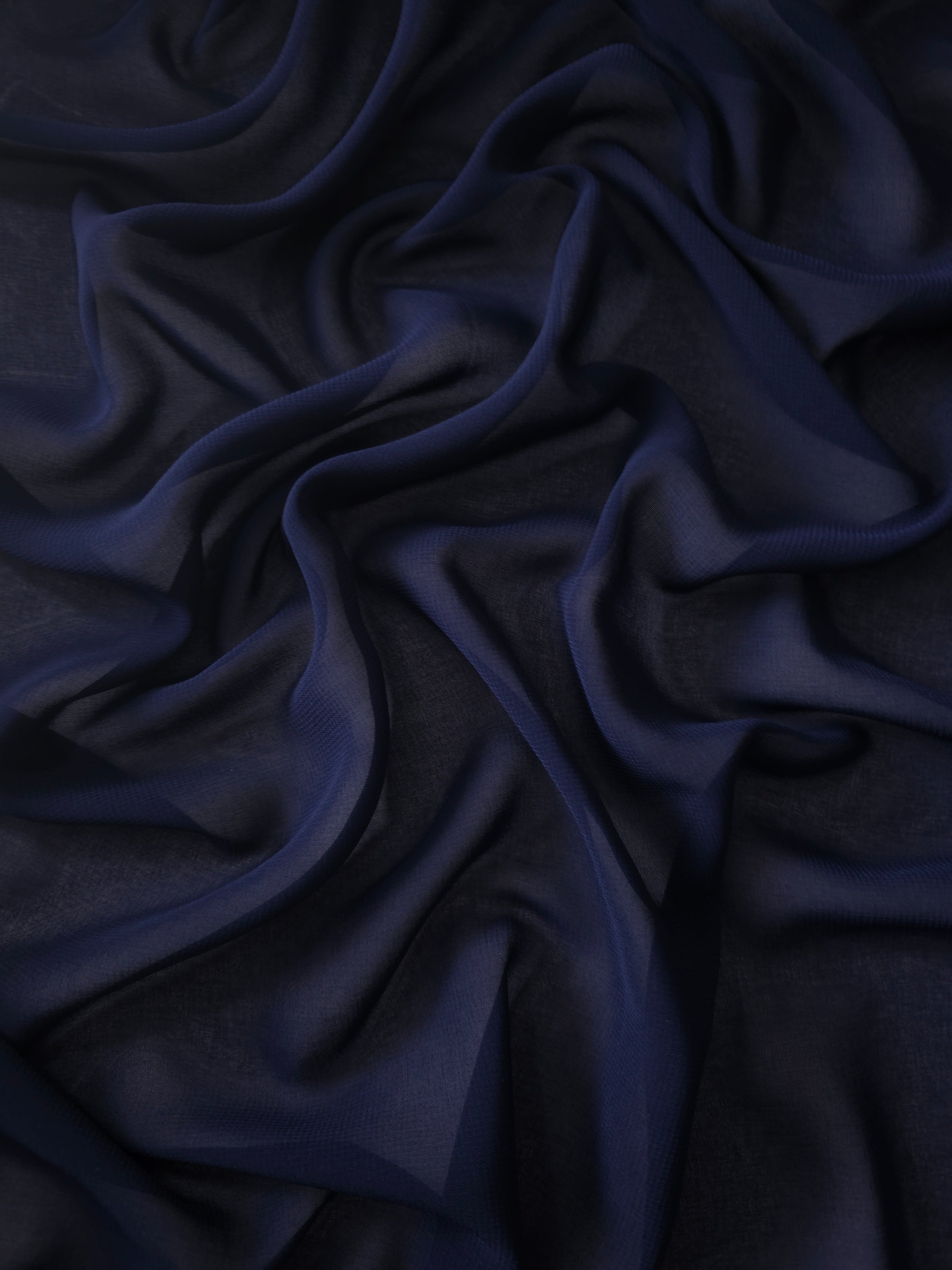 Midnight Navy stretch chiffon arranged in long draped folds to show movement for evening gowns, bridesmaid dresses and flowing formal skirts.
