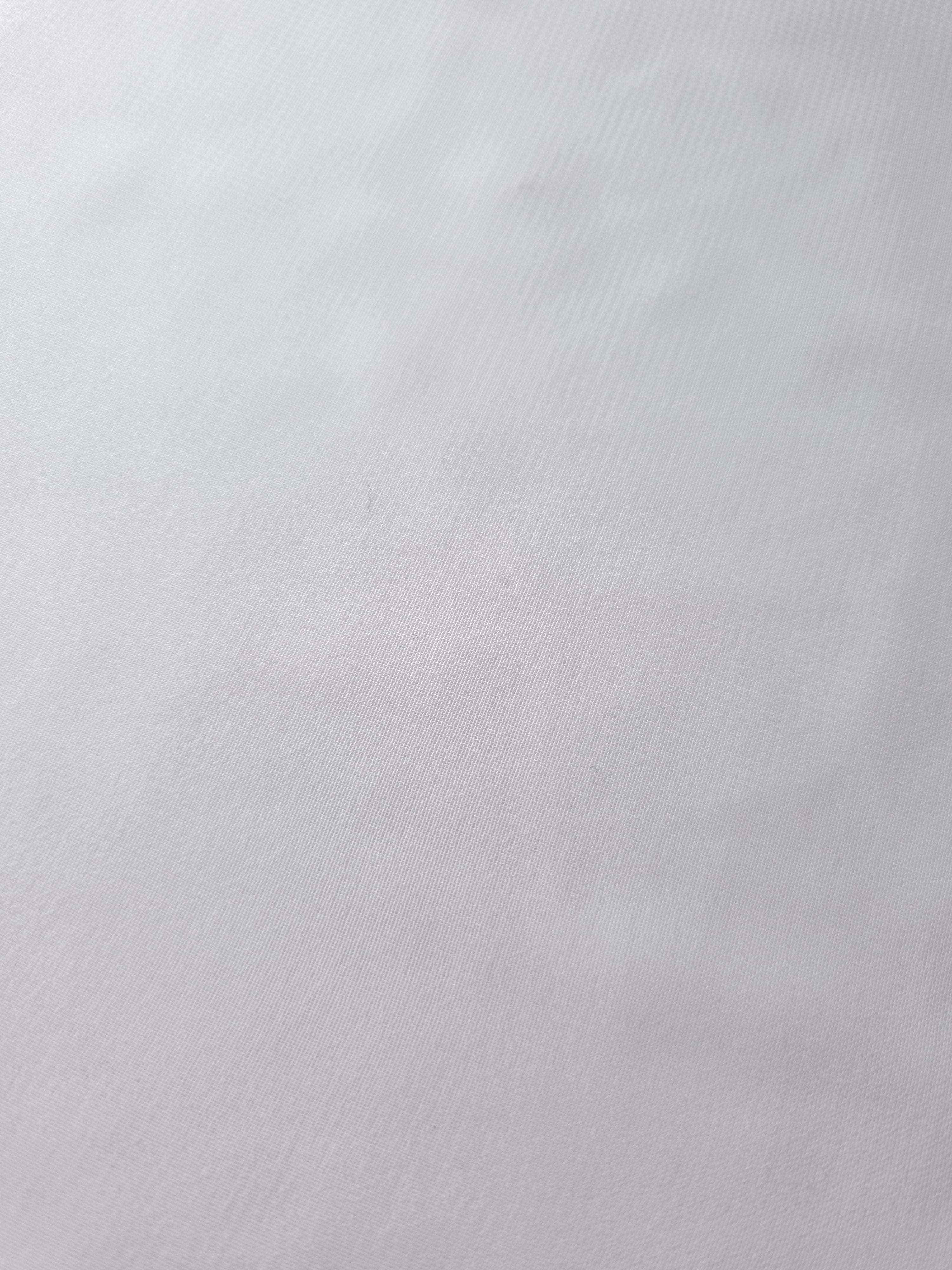 Texture view of Optic White stretch chiffon, capturing the fine sheer character used for sheer wedding sleeves, ruffles and delicate dress inserts.